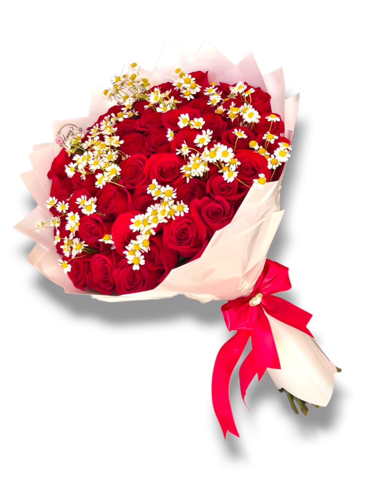 Bouquet of red roses with small white daisies and pink wrapping