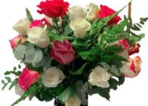 Bouquet of red, pink, and white roses with greenery