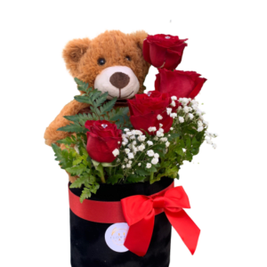 Teddy bear with red roses in a black box tied with a red ribbon