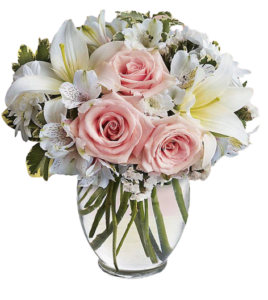 Pink roses and white lilies in a clear glass vase