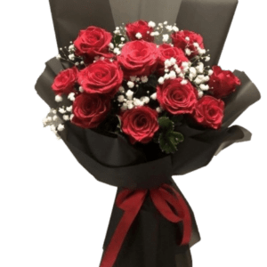 Bouquet of red roses with white baby's breath wrapped in black paper