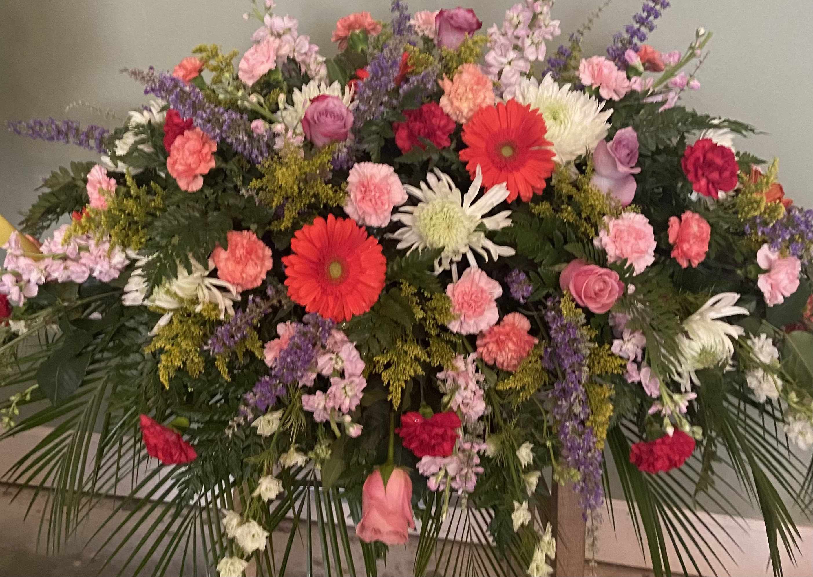 Large mixed floral spray with pink, red, and white blooms