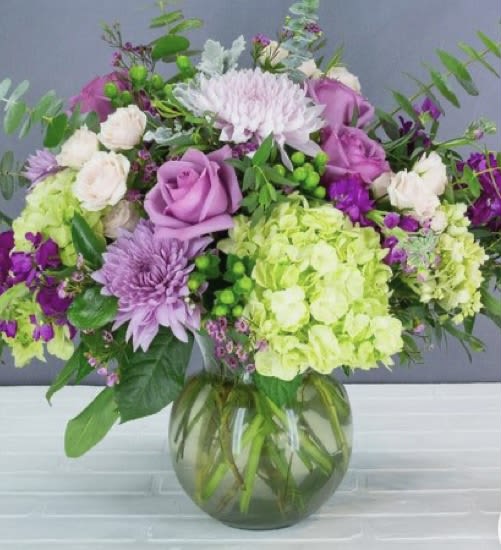 Bouquet of purple and white flowers in a glass vase