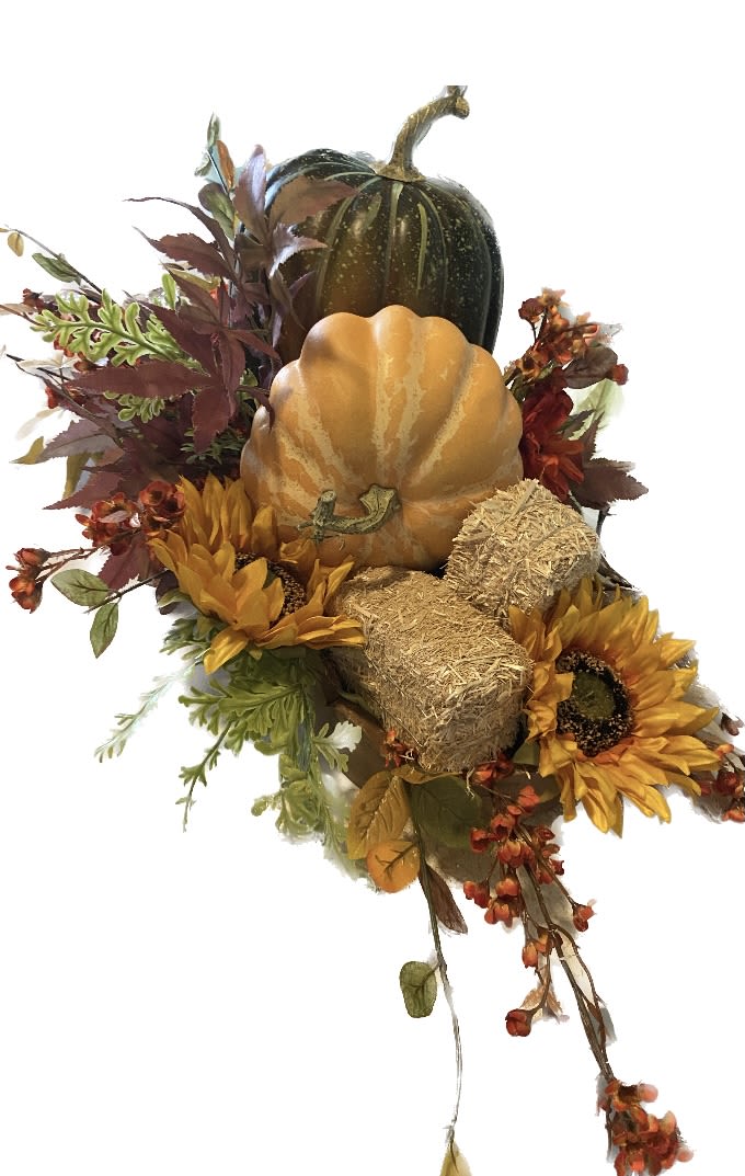 Autumn arrangement with pumpkins, sunflowers, and dried foliage
