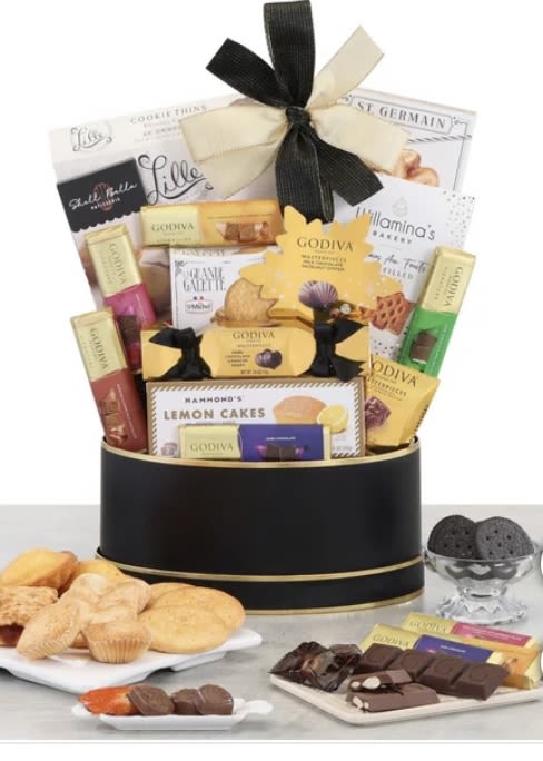 Gift basket of assorted chocolates and cookies tied with a ribbon