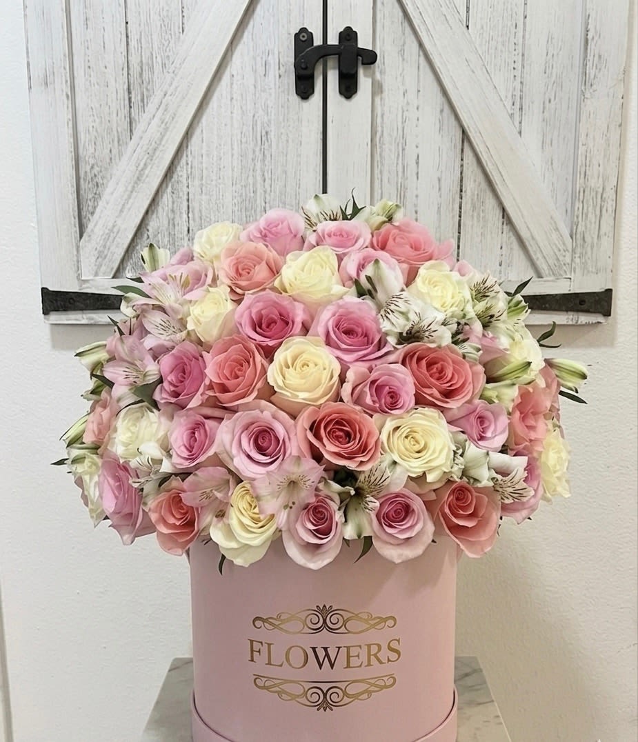 Blush &amp; Bloom - Experience the epitome of floral elegance with our Blush &amp; Bloom arrangement, a masterpiece designed to captivate and charm. This lush, dome-shaped display features a curated selection of premium roses in romantic shades of creamy ivory, soft ballet pink, and deep dusty rose, accented by the delicate, whimsical petals of white alstroemeria. Whether you are celebrating a milestone or simply brightening a home, Blush &amp; Bloom delivers a sense of timeless luxury and effortless grace that lingers long after the first look.