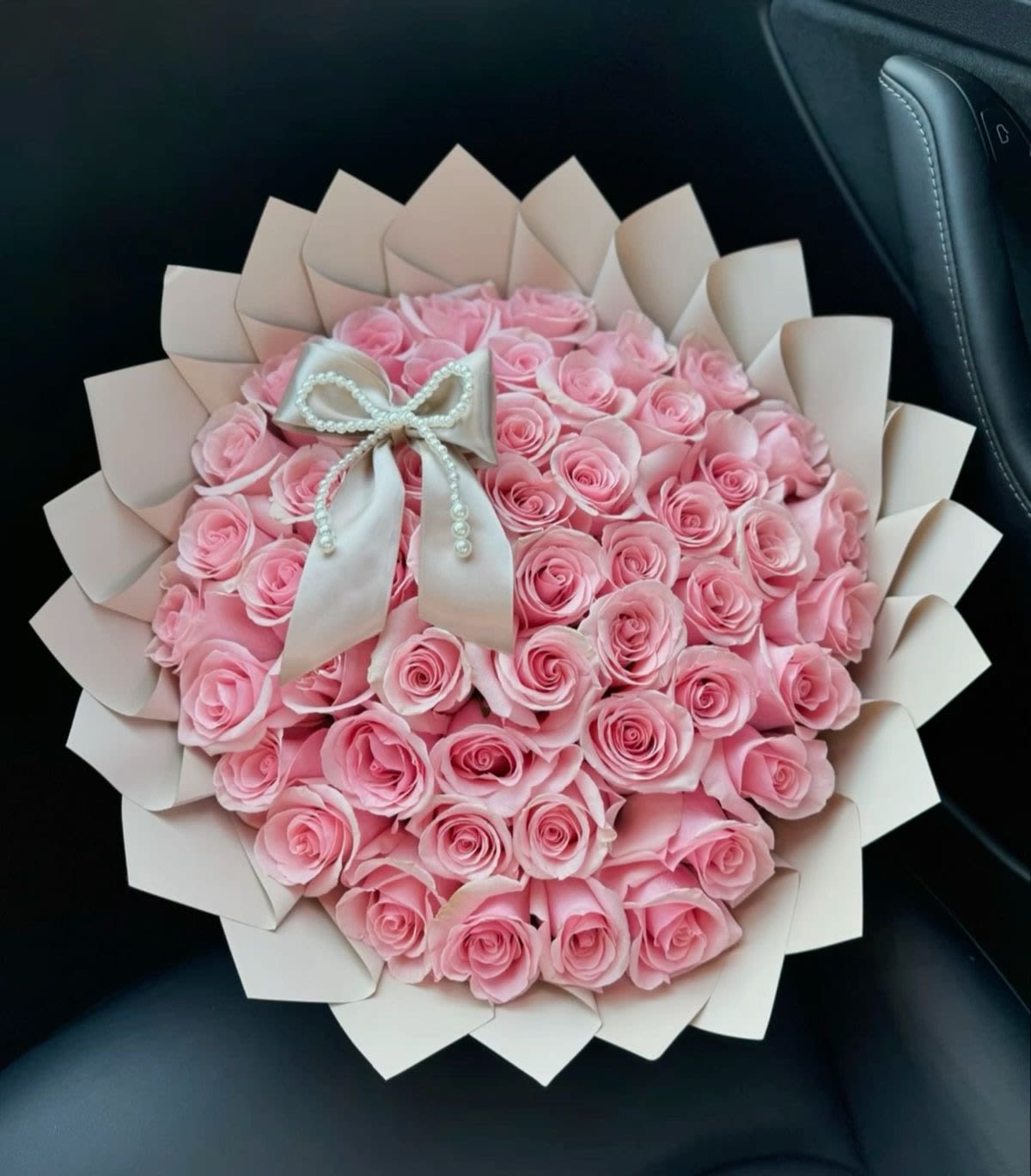 My Sweet Love - Soft, romantic and gift-ready, this blush pink rose bouquet is perfect as an anniversary roses arrangement or a birthday bouquet for the one you adore. The rounded, dome-like cluster of tightly packed pink and white roses gives an immediate impression of abundance and tenderness - the kind of bouquet that makes her feel cherished and truly seen.  Each bloom is nestled in pale blush decorative paper folded with petal-like edges, tied with a satin ribbon and finished with delicate pearl embellishments for a polished, feminine touch. The compact, hand-tied design arrives ready to present; ideal for anniversaries, romantic gestures, birthdays, or a heartfelt thank-you. Lightly mist the stems and trim before placing in fresh water to help the roses open and last longer.