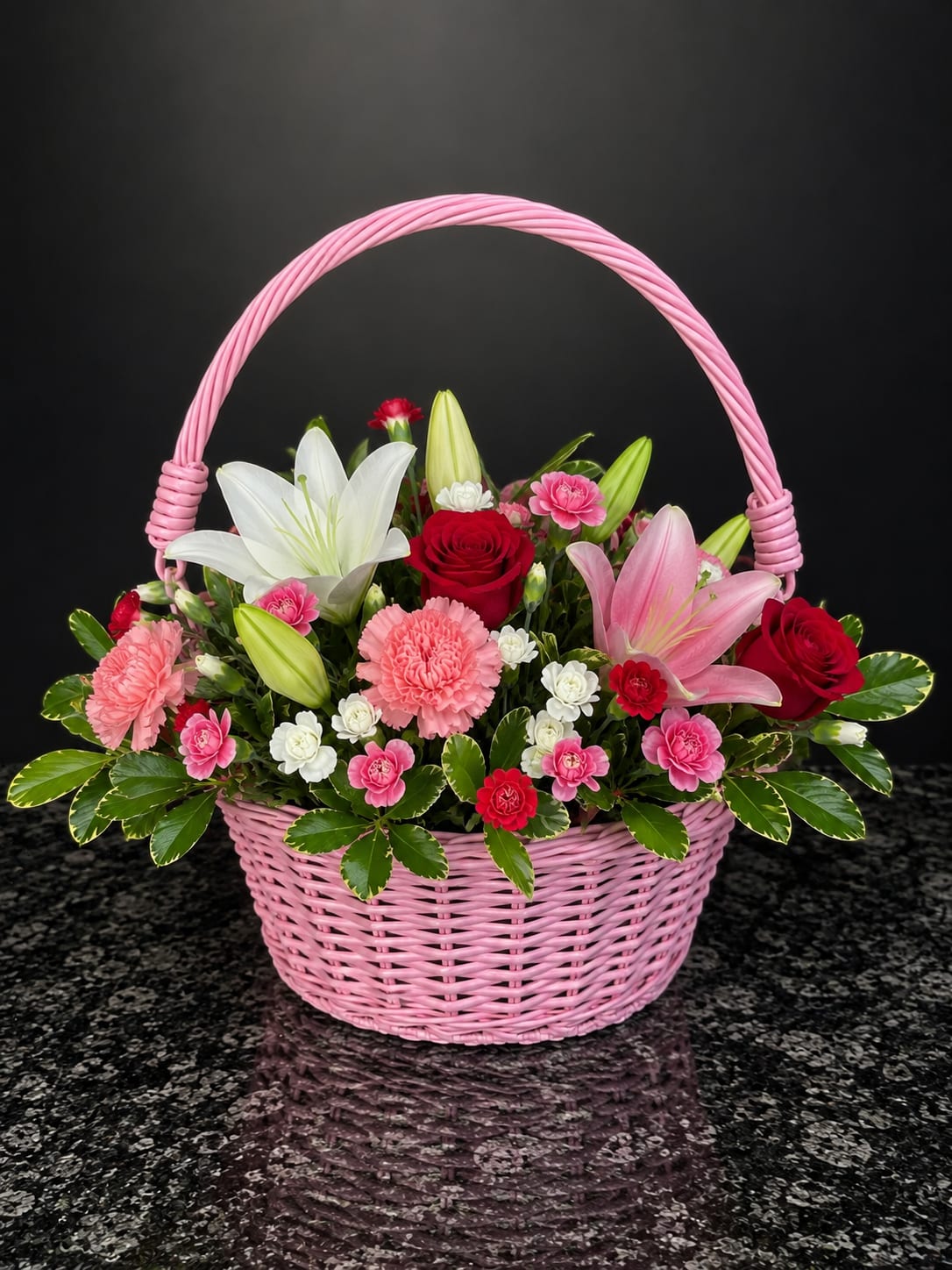 Pink basket of lilies, roses, and carnations
