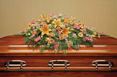 Large floral spray on a wooden casket