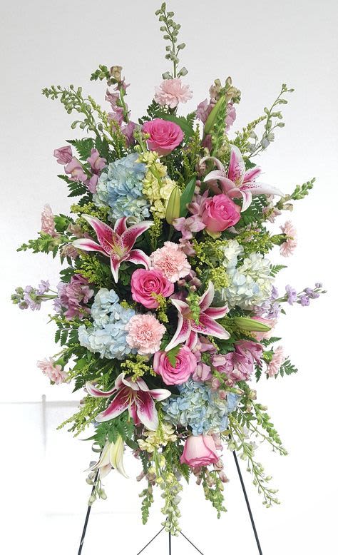 Standing spray of pink and blue flowers with lilies and roses