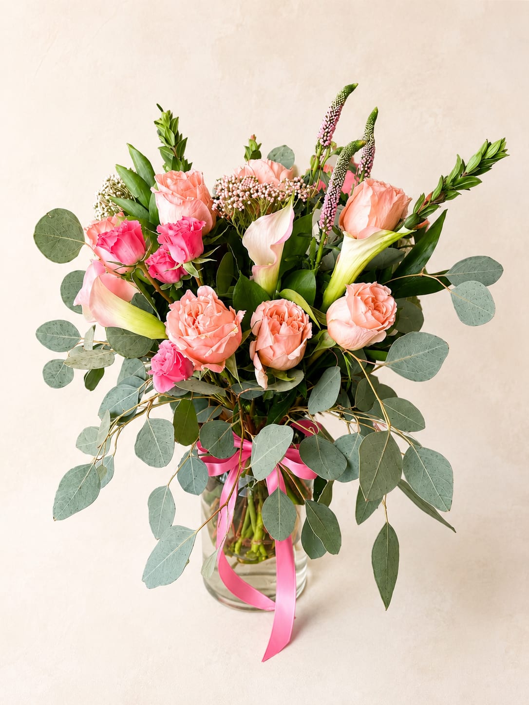 Anahit's Garden – Luxury Garden Vase Arrangement - Inspired by Anahit, the Armenian goddess of beauty, wisdom, and flourishing gardens, this arrangement reflects graceful elegance and the gentle beauty of nature in bloom.  Designed in Flower Fairy's signature garden style, this luxury vase arrangement features peach roses, delicate calla lilies, pink spray roses, veronica, eucalyptus, and carefully selected seasonal flowers. Soft shades of blush, peach, ivory, and fresh green create an airy, naturally flowing composition with timeless sophistication. Presented in a clear glass vase with a satin ribbon, it brings effortless elegance to any home or celebration.  Perfect for birthdays, anniversaries, Mother's Day, baby showers, thank-you gifts, congratulations, housewarmings, or simply letting someone know you're thinking of them.  Each arrangement is handcrafted by Flower Fairy using the freshest flowers available. While occasional substitutions may be necessary due to seasonal availability, we always preserve the overall style, color palette, and premium quality of every design.  Features: Luxury vase arrangement Peach roses Calla lilies Pink spray roses Fresh eucalyptus Seasonal flowers Garden-style floral design Handcrafted by Flower Fairy Same-day flower delivery in Phoenix