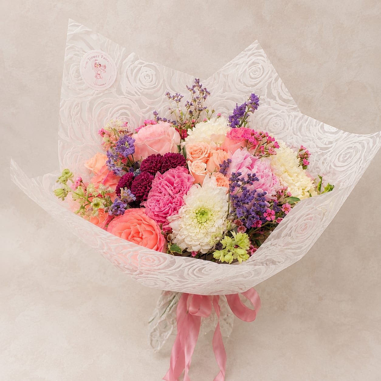 Designer's Choice Wrapped Bouquet – Seasonal Luxury Flowers - Let our floral designers create something truly unique. Our Designer's Choice Wrapped Bouquet is handcrafted using the freshest seasonal flowers available each day, allowing every bouquet to showcase the best blooms while reflecting Flower Fairy's signature garden-inspired style.  Each bouquet is thoughtfully designed with a harmonious blend of premium flowers, seasonal accents, fresh greenery, and elegant waterproof wrapping finished with a satin ribbon. No two bouquets are exactly alike, making every arrangement a personal and one-of-a-kind gift.  Perfect for birthdays, anniversaries, congratulations, thank-you gifts, Mother's Day, get well wishes, or simply brightening someone's day. If you love beautiful flowers but prefer to leave the creative details to our designers, this is the perfect choice.  Each bouquet is handcrafted by Flower Fairy using the freshest flowers available. While flower varieties and colors will vary based on seasonal availability, we always preserve the overall style, color palette, and premium quality of every design.  Features  Designer's Choice bouquet Seasonal premium flowers Garden-style design Luxury waterproof wrapping Satin ribbon finish Handcrafted by Flower Fairy Same-day flower delivery in Phoenix