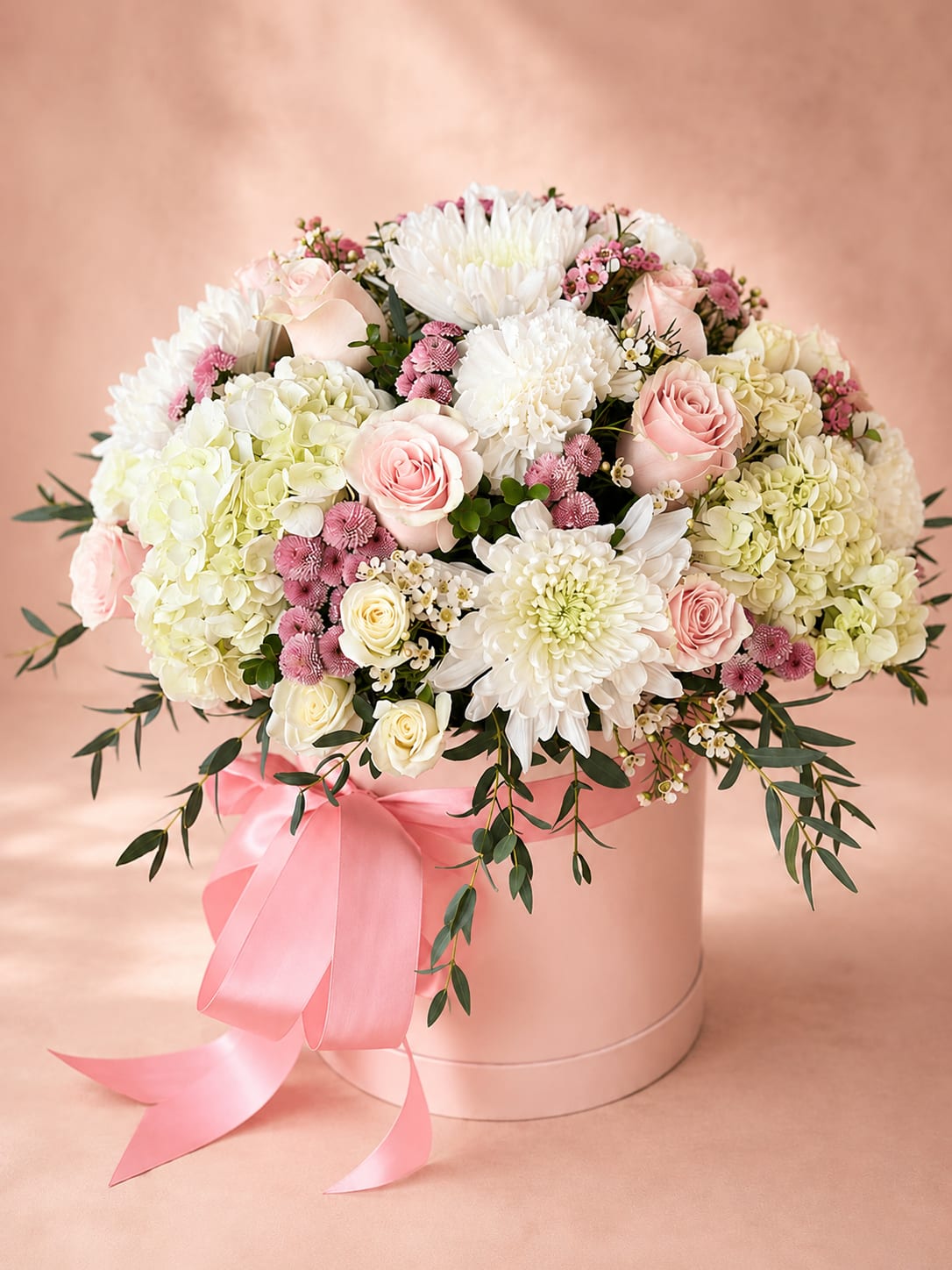 Brigid's Garden Bloom – Luxury Hat Box - Inspired by Brigid, the Celtic goddess of beauty, healing, and renewal, Brigid's Garden Bloom celebrates fresh beginnings with timeless elegance.  This lush garden-style arrangement showcases elegant white hydrangeas, premium ivory and blush roses, delicate spray roses, white chrysanthemums, soft carnations, waxflower, and flowing seasonal greenery. Designed in Flower Fairy's signature luxury keepsake hat box, it combines airy textures and gentle ivory-blush hues to create a sophisticated centerpiece that feels both graceful and abundant.  Perfect for birthdays, anniversaries, Mother's Day, baby showers, congratulations, sympathy, weddings, or simply bringing beauty into someone's home.  Each arrangement is handcrafted by Flower Fairy using the freshest premium flowers available. While occasional substitutions may be necessary due to seasonal availability, we always preserve the overall style, color palette, and luxurious presentation of every design.  Features: Premium white hydrangeas Premium ivory and blush roses Premium spray roses White chrysanthemums Carnations Waxflower Fresh seasonal greenery Luxury keepsake hat box Handcrafted by Flower Fairy Same-day flower delivery throughout the Phoenix Metro Area Designed by your local Phoenix florist