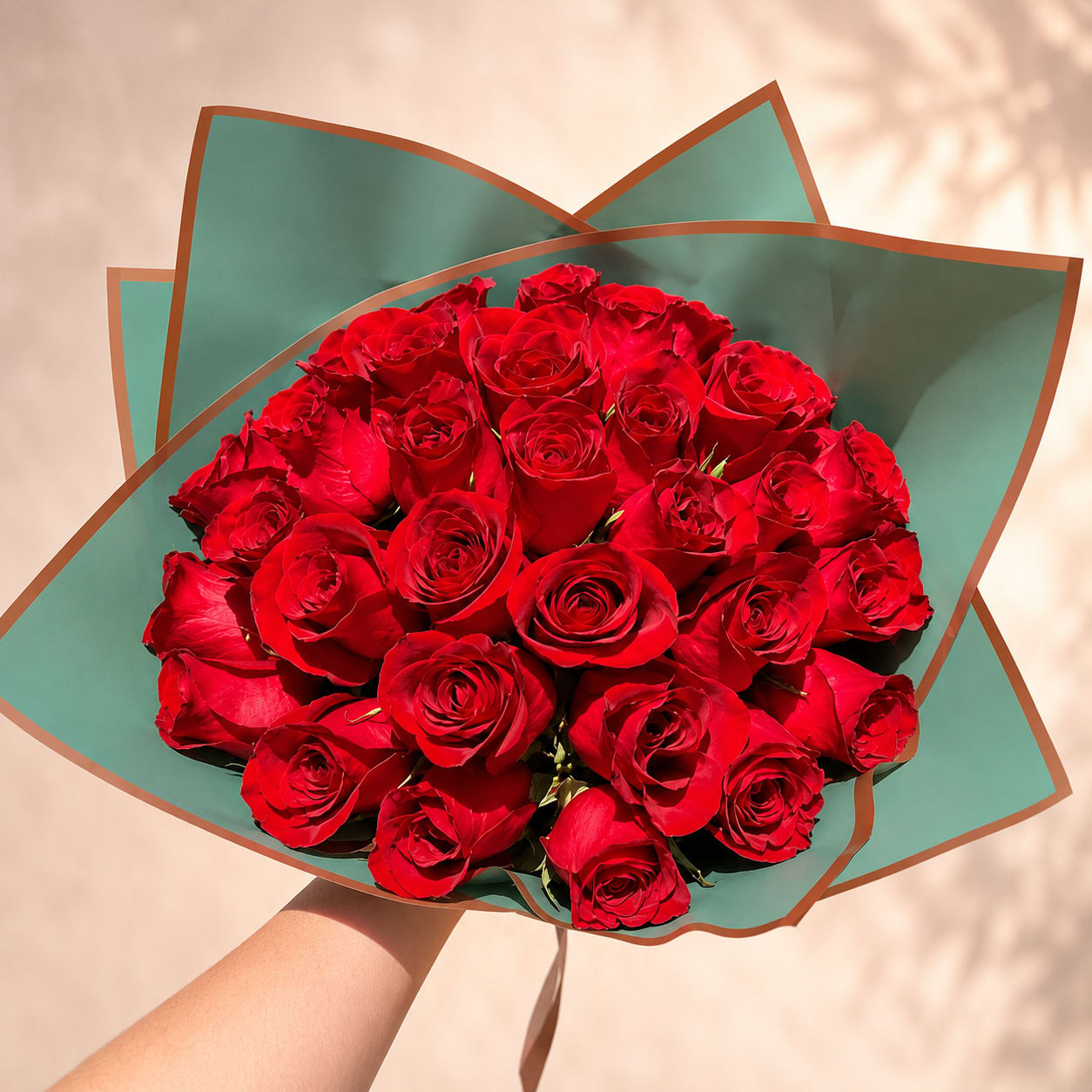 Turan's Kiss of Love – 24 Red Roses Bouquet - Inspired by Turan, the Turkic goddess of love, beauty, and harmony, this elegant bouquet celebrates romance in its purest form.  Turan's Kiss of Love features two dozen luxurious premium red roses, carefully hand-tied and wrapped in elegant waterproof designer paper with a satin ribbon. Rich crimson blooms create a classic romantic statement that's perfect for anniversaries, birthdays, Valentine's Day, proposals, or simply reminding someone how deeply they are loved.  Simple, timeless, and unforgettable, this bouquet lets the beauty of premium roses speak for itself.  Each bouquet is handcrafted by Flower Fairy using the freshest premium roses available. Wrapping color may vary upon request or seasonal availability while maintaining the bouquet's luxurious presentation.  Features: 24 premium red roses Elegant waterproof designer wrapping Satin ribbon finish Hand-tied by Flower Fairy Long-stem premium roses Available in multiple rose colors upon request Same-day flower delivery throughout the Phoenix Metro Area