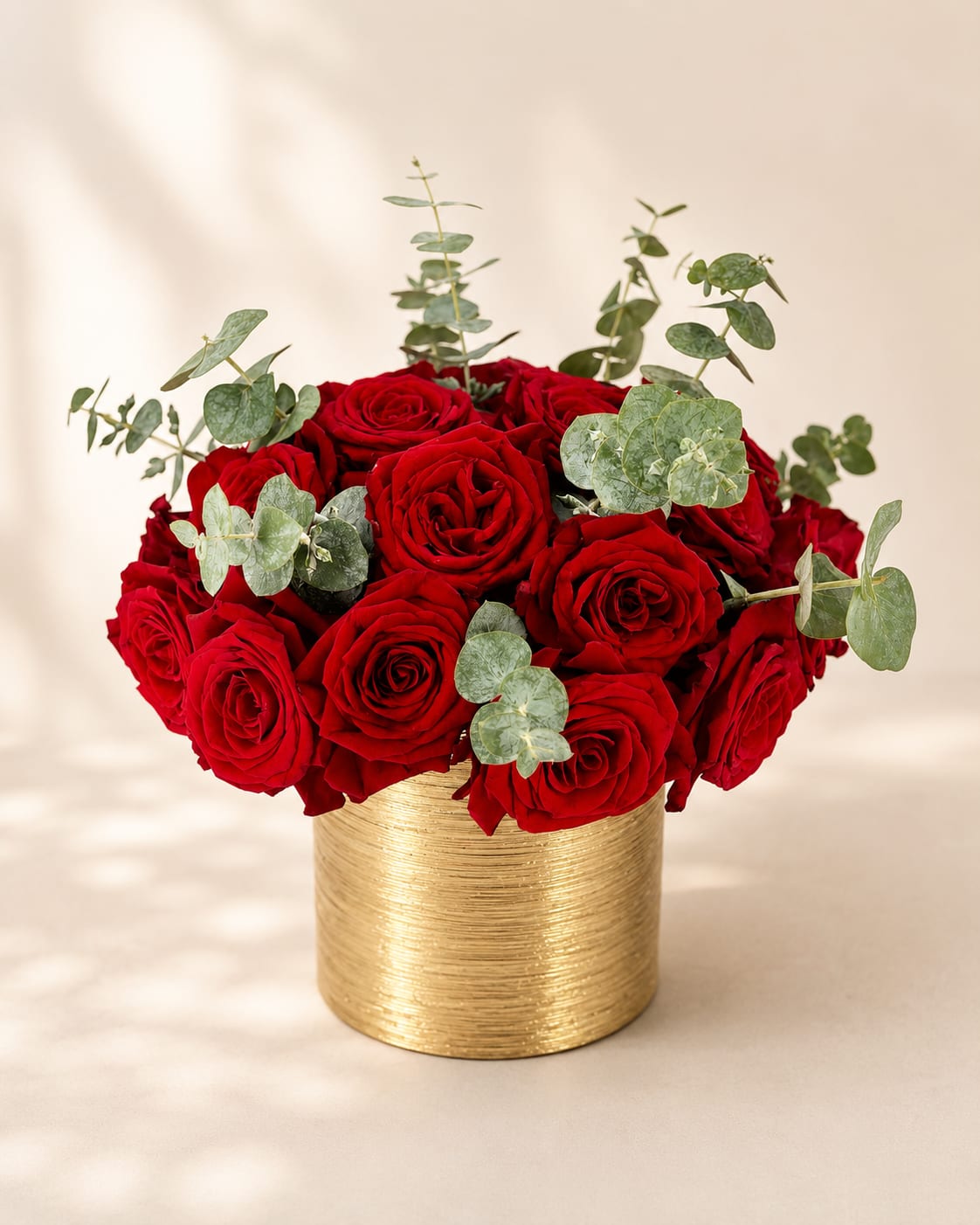 Freya's Crimson Elegance – Luxury Rose Vase Arrangement - Inspired by Freya, the Norse goddess of love, beauty, and prosperity, this arrangement celebrates timeless romance with refined elegance.  Designed in Flower Fairy's signature style, this luxury vase arrangement features premium red roses complemented by fresh eucalyptus in a modern gold keepsake vase. The rich crimson blooms paired with soft silver-green foliage create a sophisticated composition that feels both classic and contemporary. Elegant, graceful, and effortlessly luxurious, it's designed to make every meaningful occasion unforgettable.  Perfect for anniversaries, Valentine's Day, birthdays, romantic celebrations, congratulations, or simply expressing love and appreciation.  Each arrangement is handcrafted by Flower Fairy using the freshest flowers available. While occasional substitutions may be necessary due to seasonal availability, we always preserve the overall style, color palette, and premium quality of every design.  Features: Premium red roses Fresh eucalyptus Gold keepsake vase Luxury rose vase arrangement Handcrafted by Flower Fairy Same-day flower delivery in Phoenix