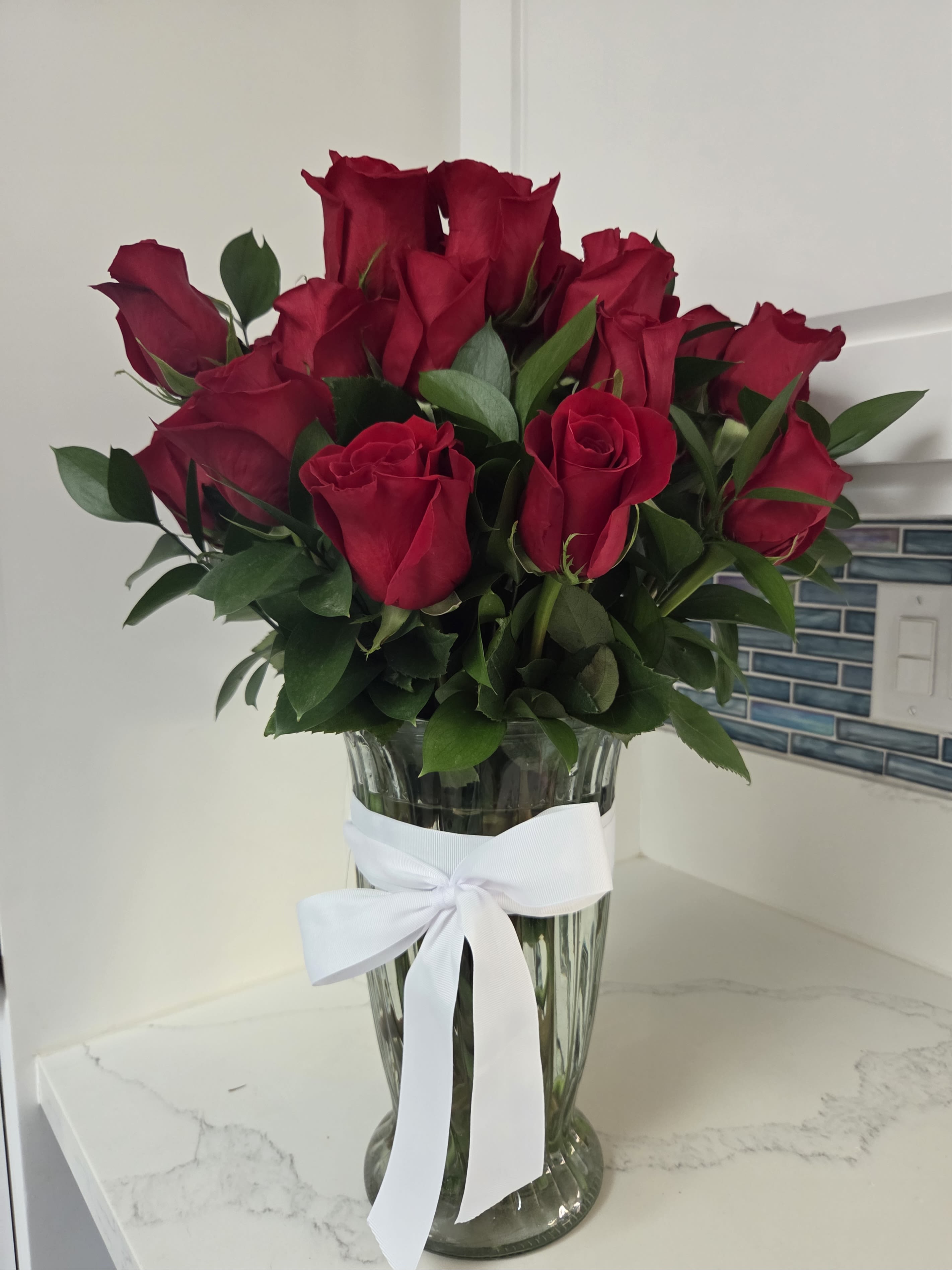 Double Red Dozen - Double the beauty of these classic lovelies by ordering 24 long stem roses.  Displayed in a clear glass vase.