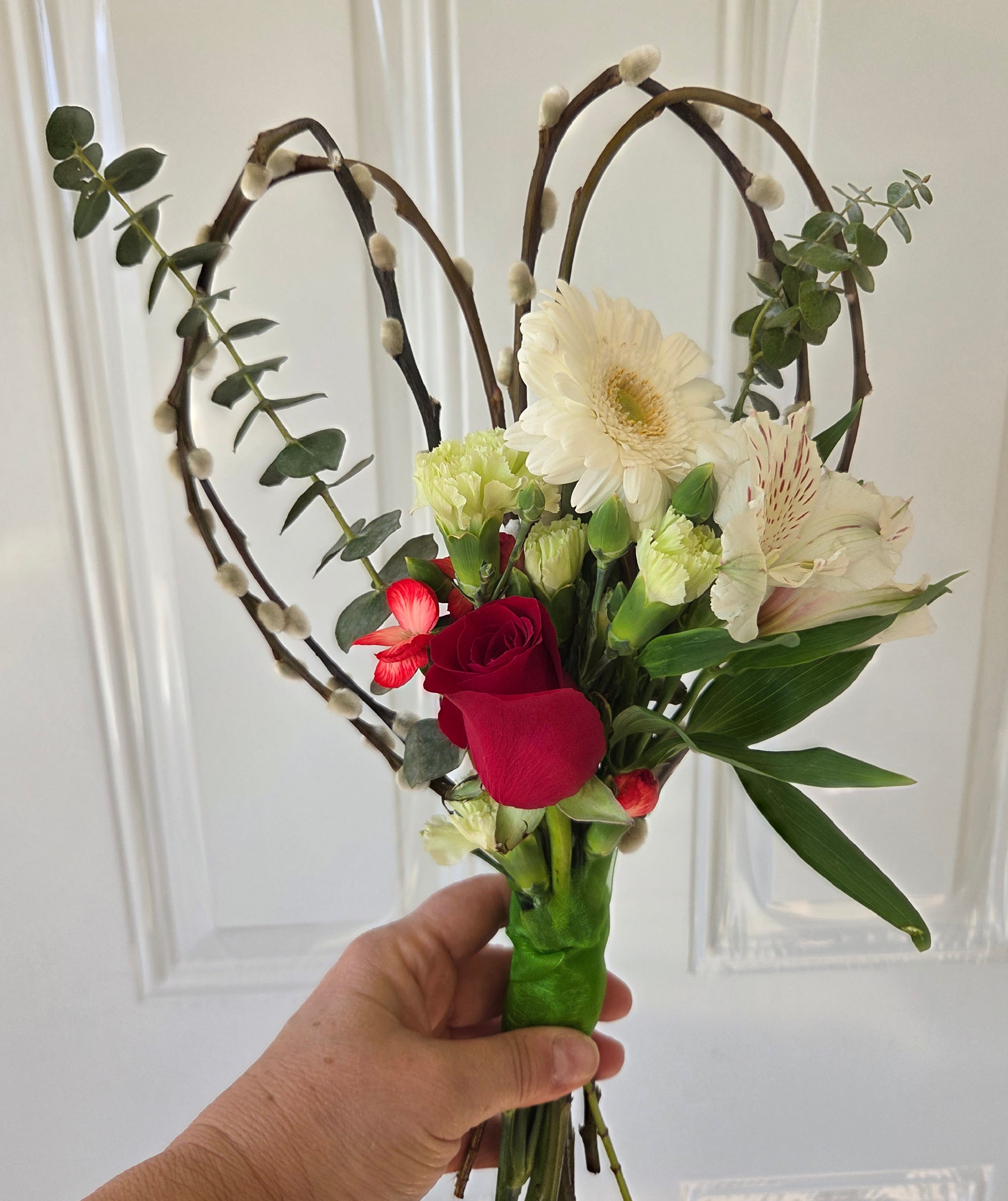 Handheld bouquet with red roses, white gerbera daisies, and alstroemeria