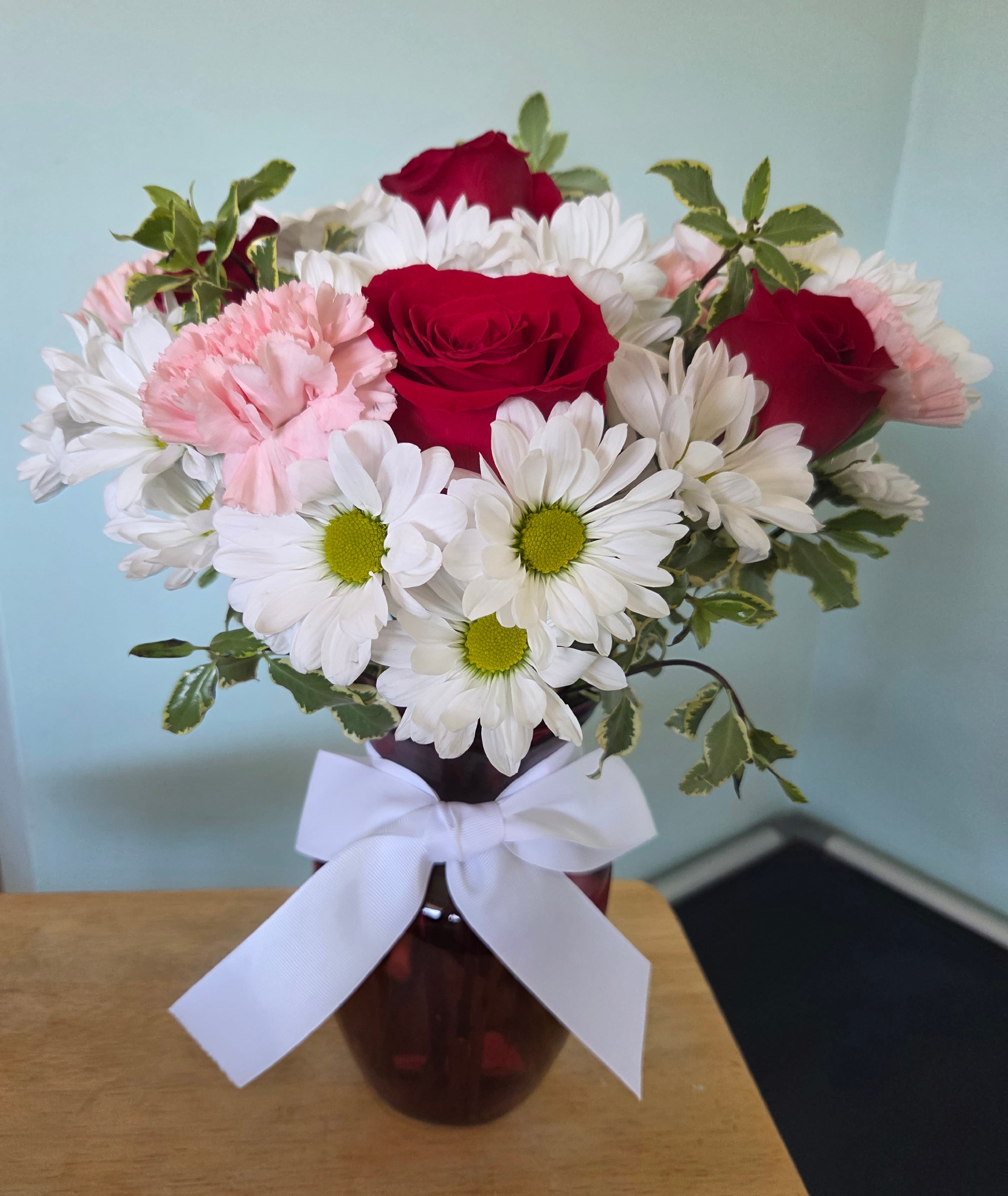Bold Yet Bashful - Filled with 14-18 stems of white, pink and red.  Displayed in a red glass vase.  