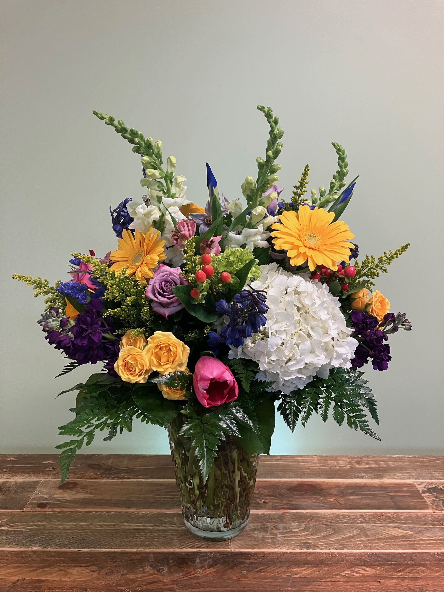 Colorful mixed flower arrangement in a glass vase