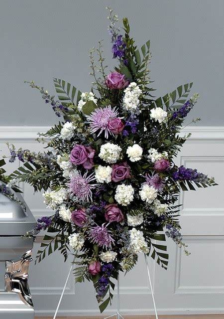 Blissful - This beautiful spray has Purple Roses, Lavender Spider Mums, White Carnations, White Stock and Blue Delphinium with beautiful greenery..