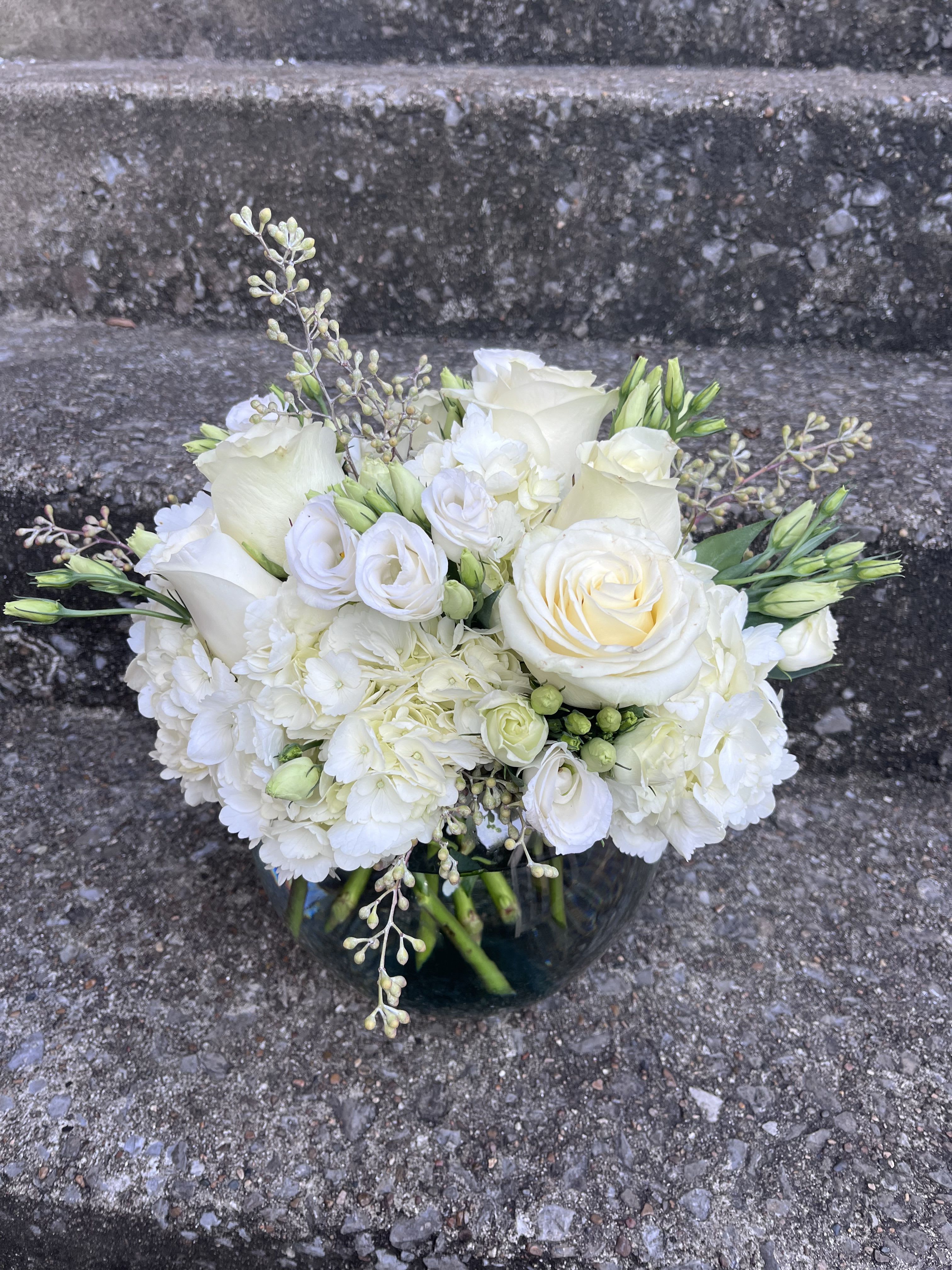 White Bliss  - This arrangement is in a 8 inch bubble bowl vase. There is hydrangeas, roses, lisianthus and eucalyptus. 