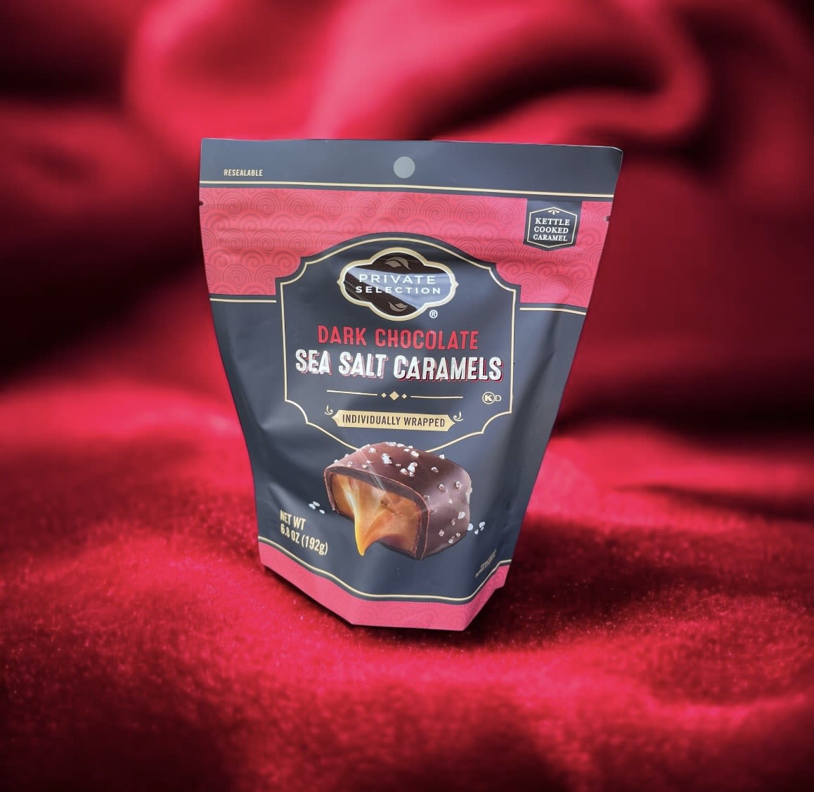 Bag of dark chocolate sea salt caramels on red fabric