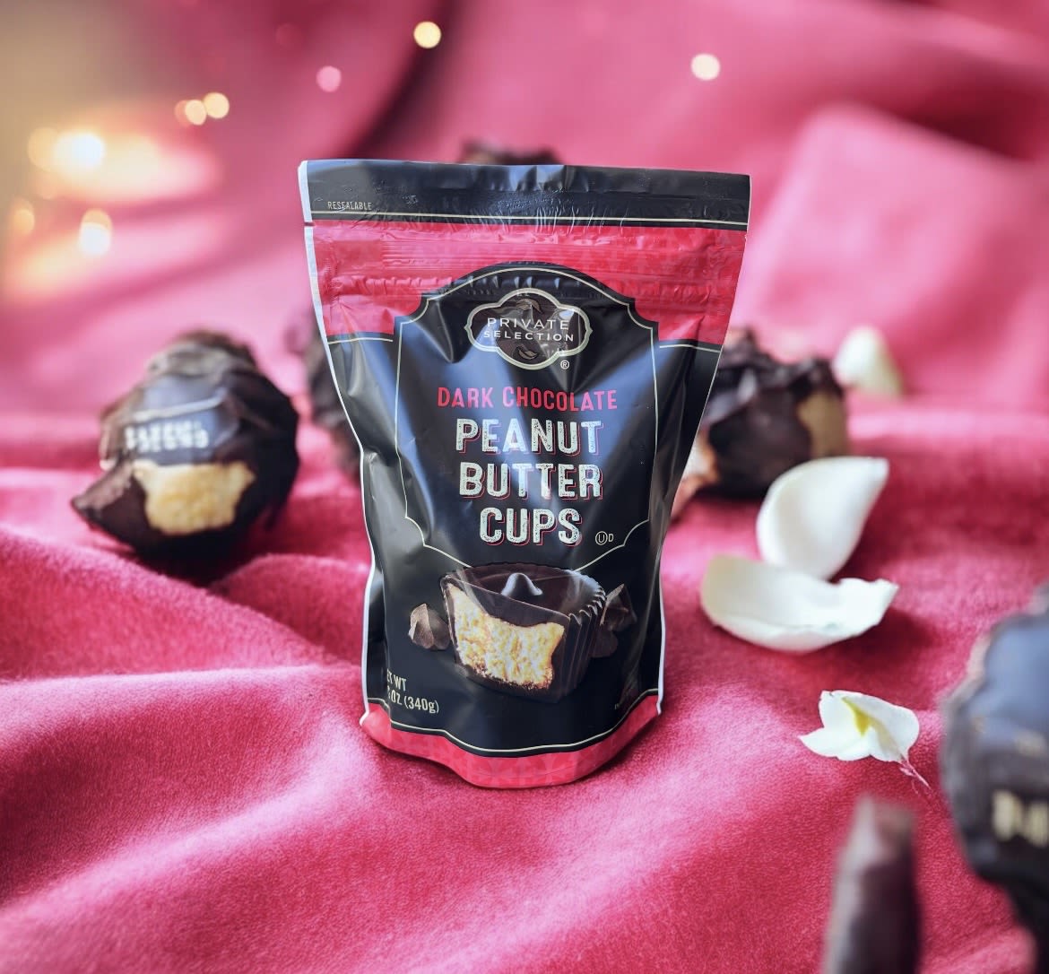 Bag of dark chocolate peanut butter cups on pink fabric