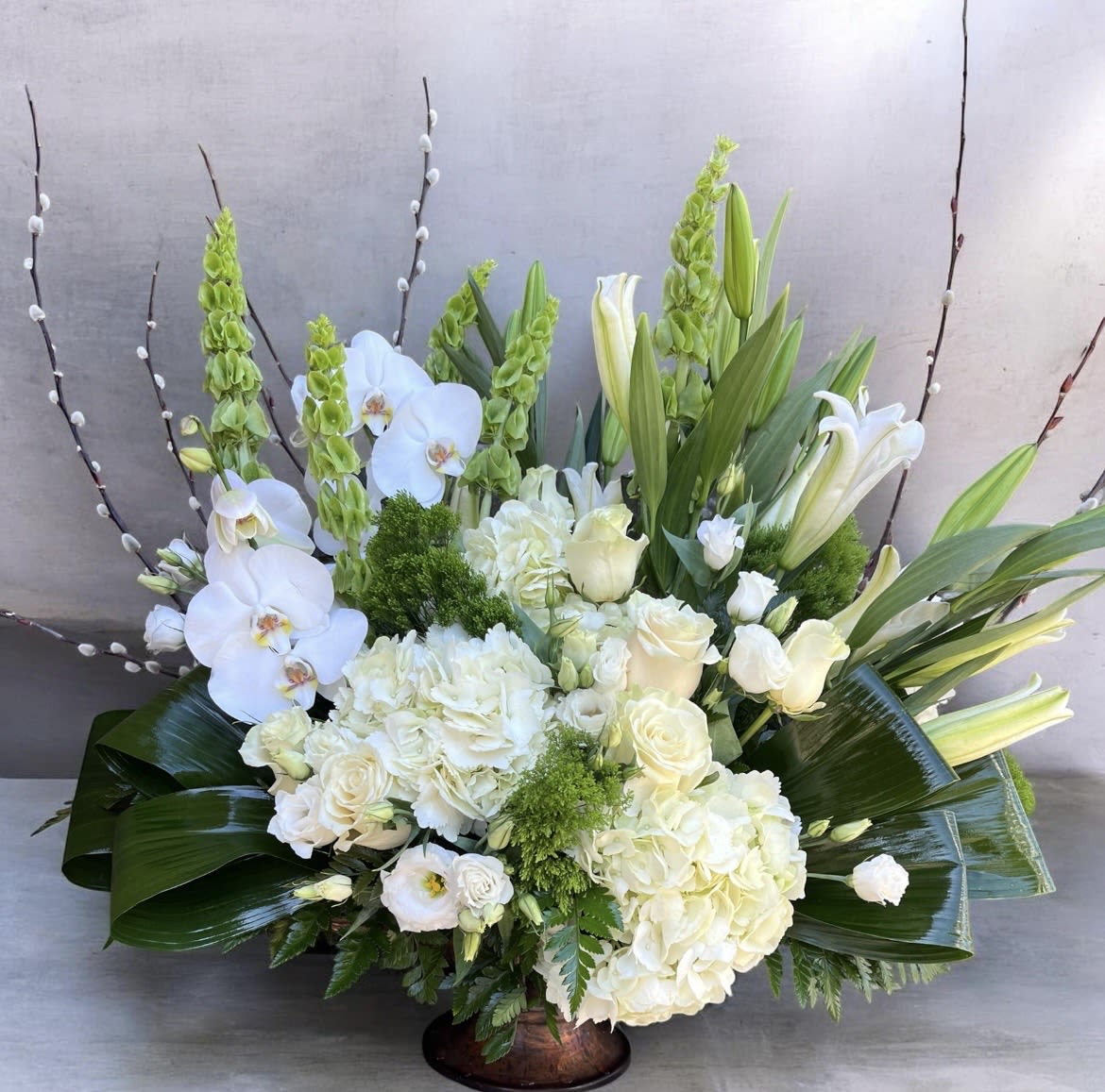 Ivory Elegance  - This hydrangeas, orchids, pussy willow, bells of Ireland, green trick, roses, stargazer, lilies, aspidistra, lisianthus and greenery.