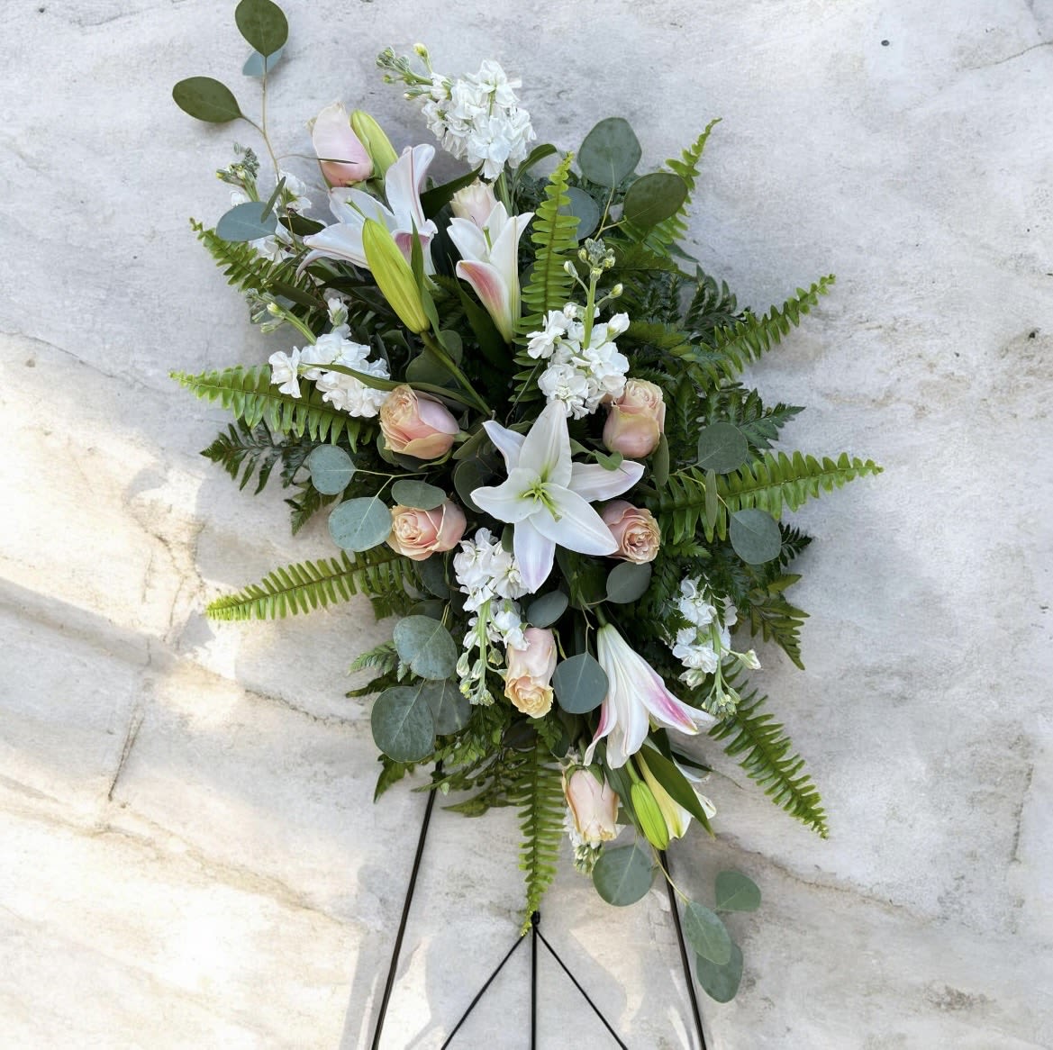 Blushing Elegance - This arrangement has stock, roses, lilies silver, dollar eucalyptus, fern, and other greenery