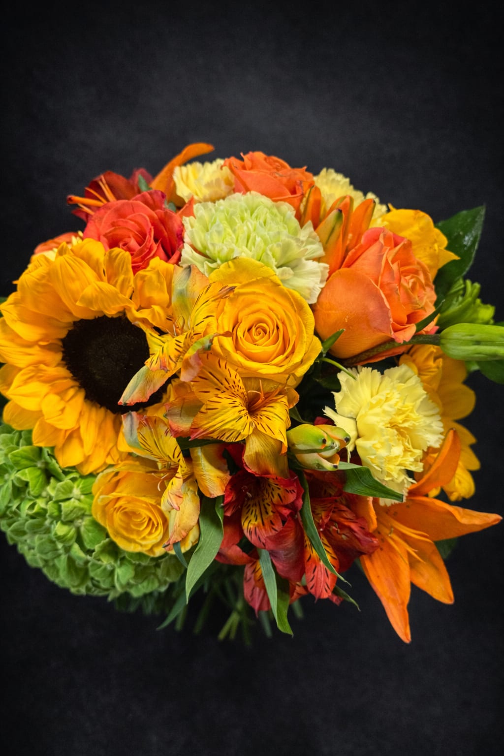 Shinning Star - Bright flowers arranged in a lower vase. Perfect for an office or centerpiece setting. 