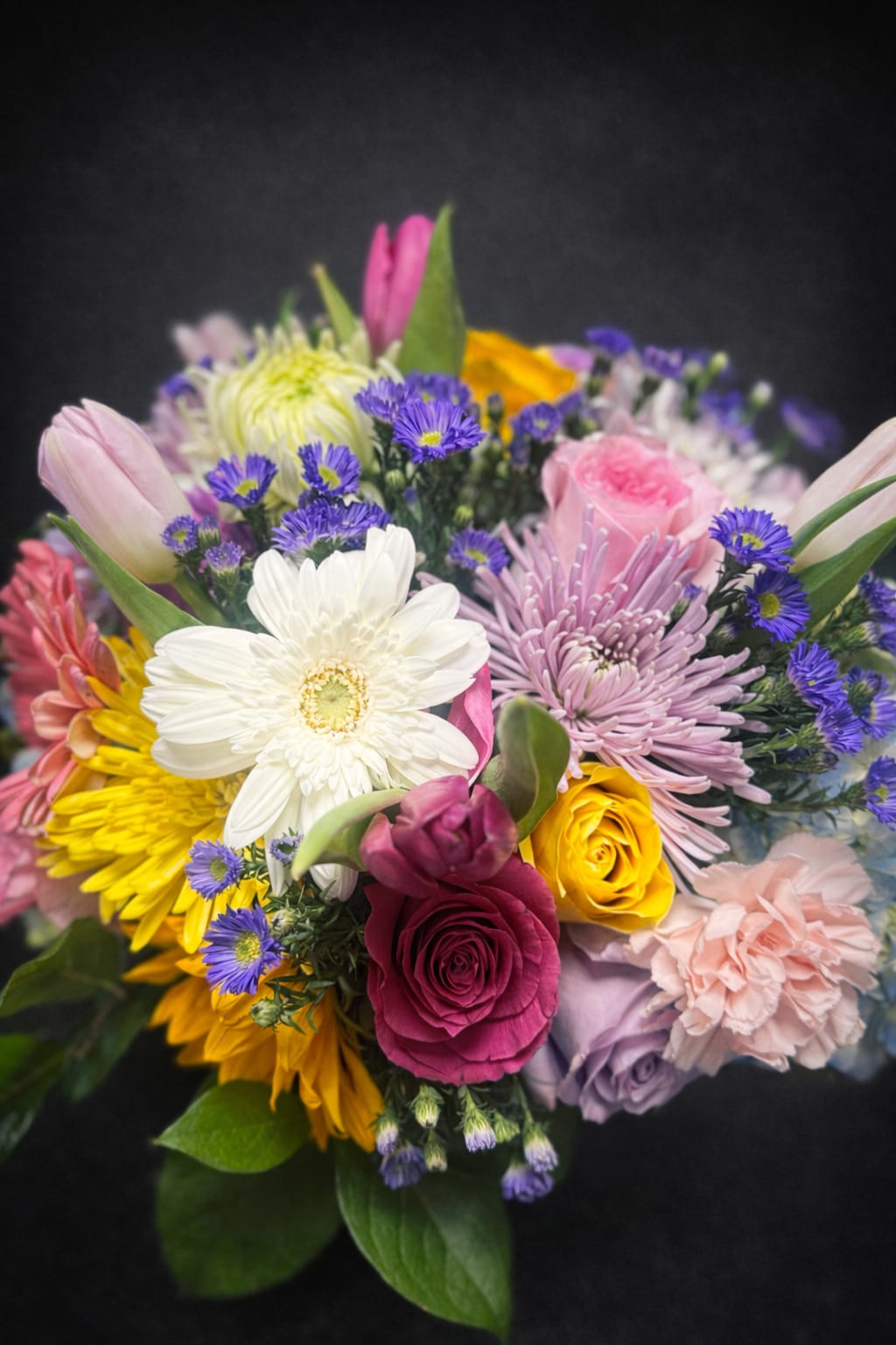 Pastel Surprise - A soft pink colored floral with pops of lavender, yellow and white mix of flowers for any occasion.
