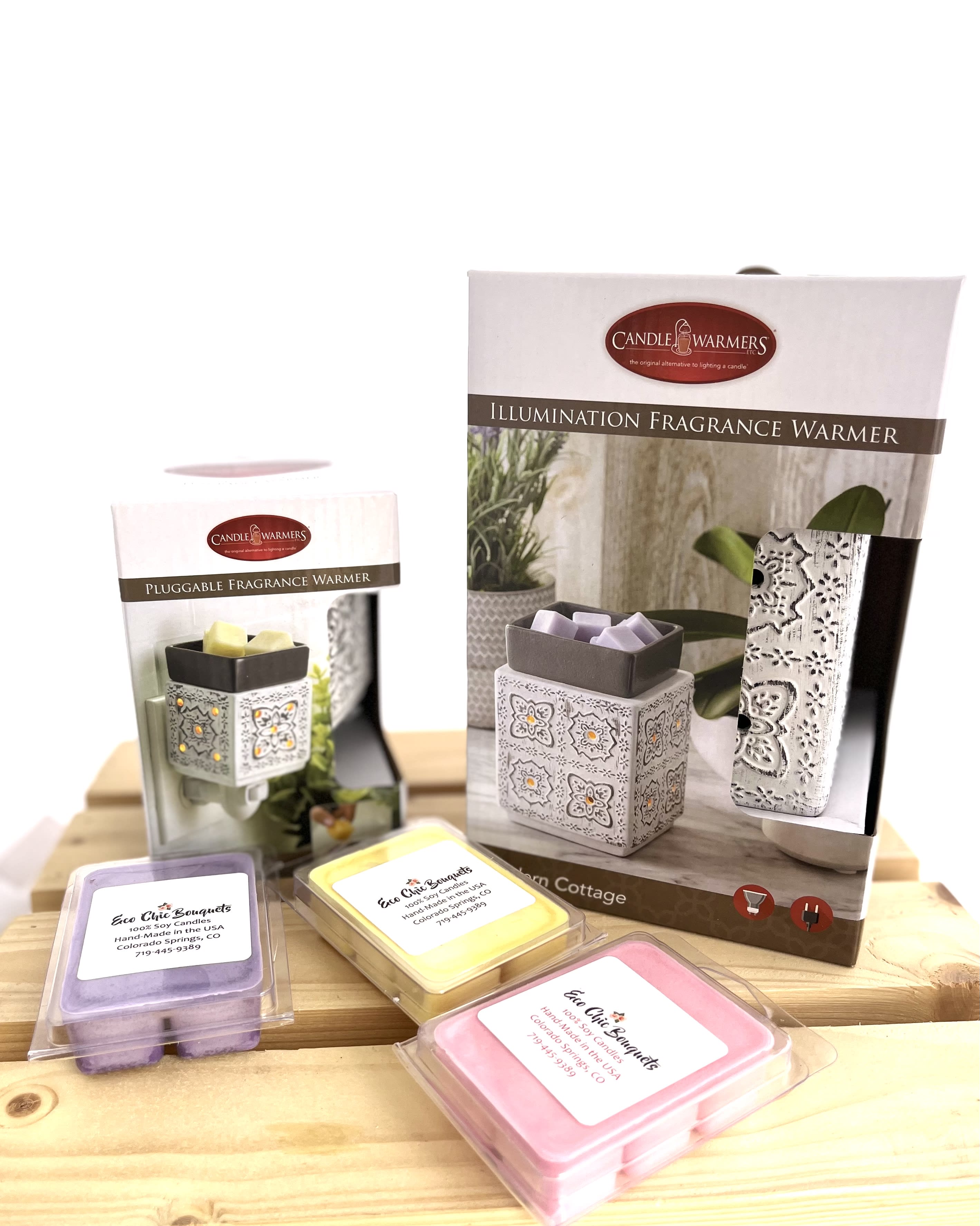 Fragrance warmer boxes with pastel wax melts on a wooden surface