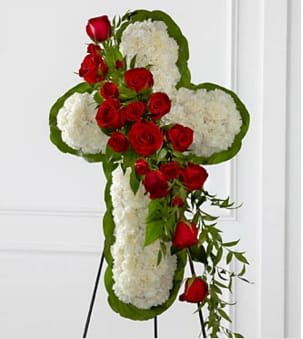 The FTD® Floral Cross Easel - The FTD® Floral Cross Easel is a symbol of love and faith to honor the deceased at the final farewell service. White carnations are arranged to form a cross in which an accent of red roses, spray roses, and lush greens are draped across the center, creating a beautiful display of serene elegance. Displayed on a wire easel. Approximately 38"H x 24"W. Your purchase includes a complimentary personalized gift message.