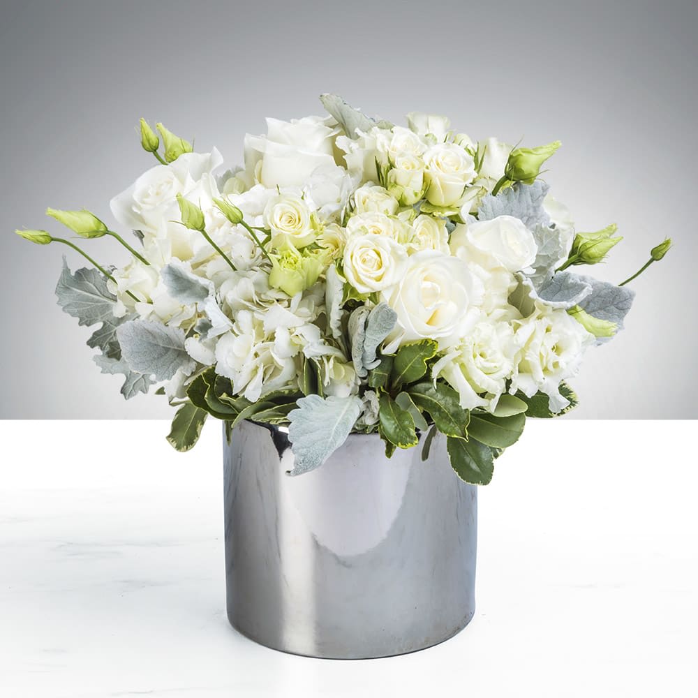 White rose arrangement in a silver cylindrical vase