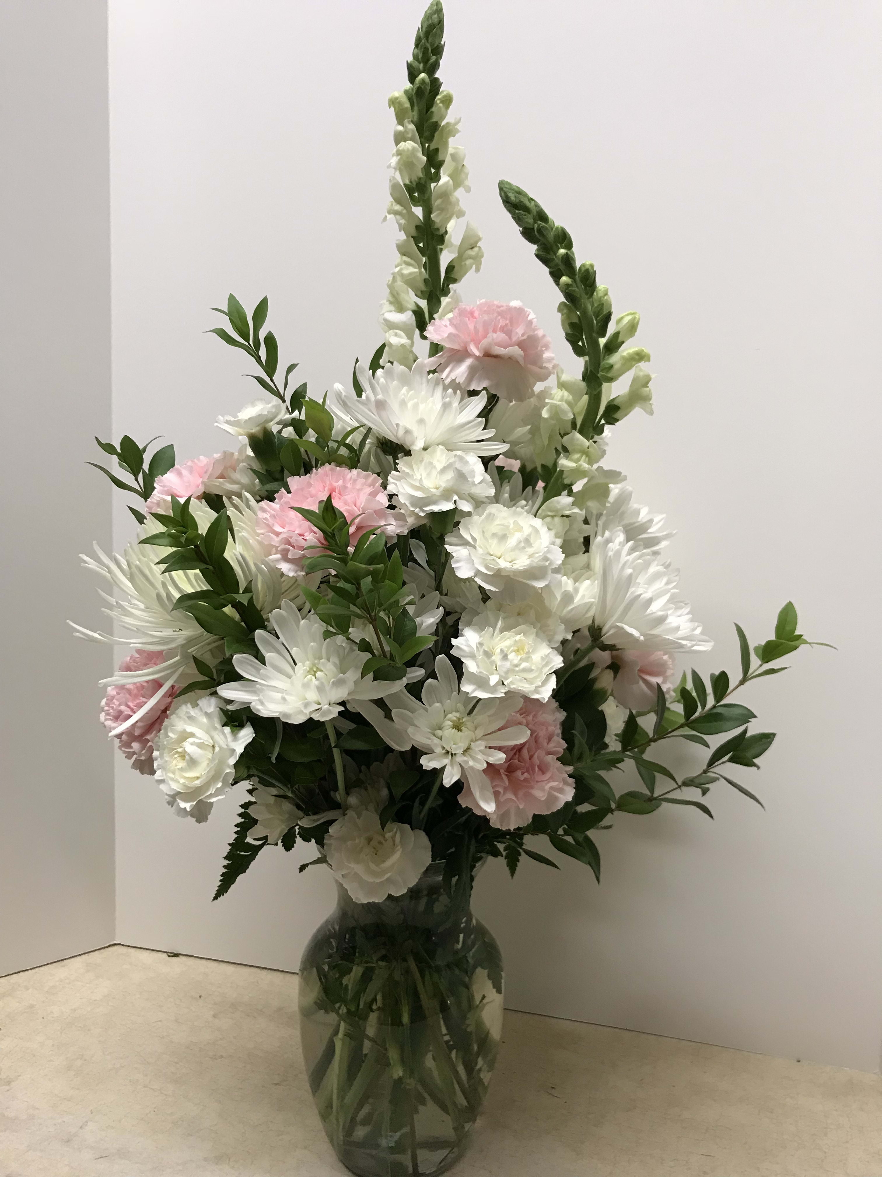 White and pink floral arrangement in a glass vase