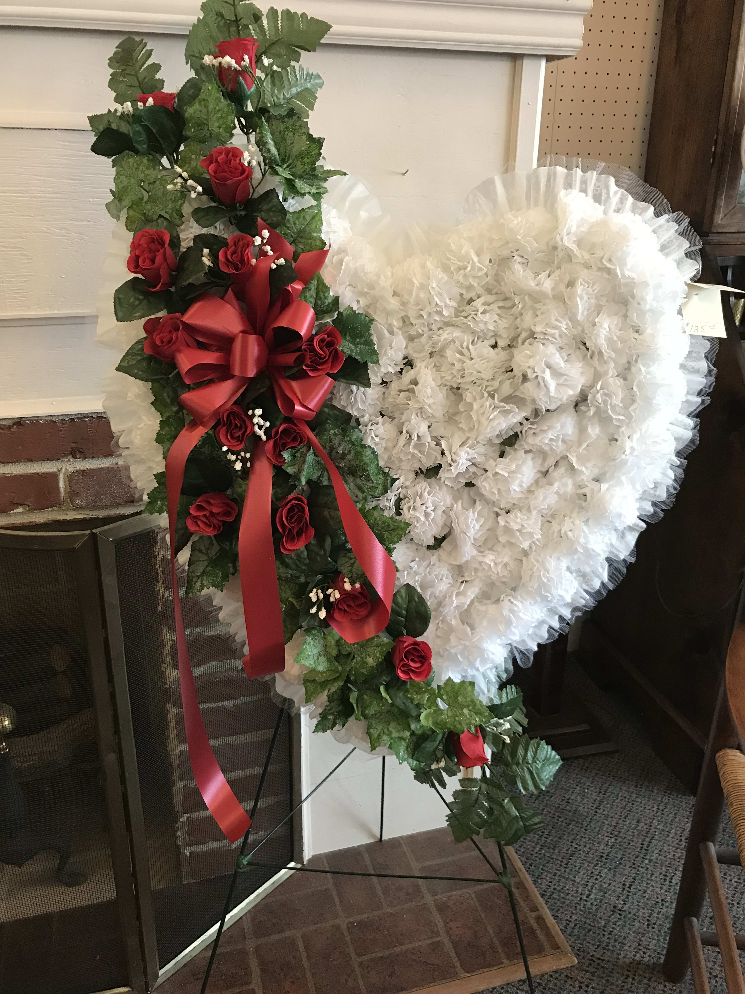 Silk Standing Heart with Red Roses - This magnificent standing heart sits upon a 42" easel and contains a background of brilliant silk white carnations, with an overflow of over 14 silk red rose buds and baby's breath spanning its' center.  A splendid way in which to honor the memory of your friend, family member, or loved one.  