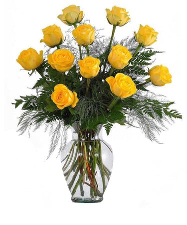 Yellow roses arranged in a clear glass vase