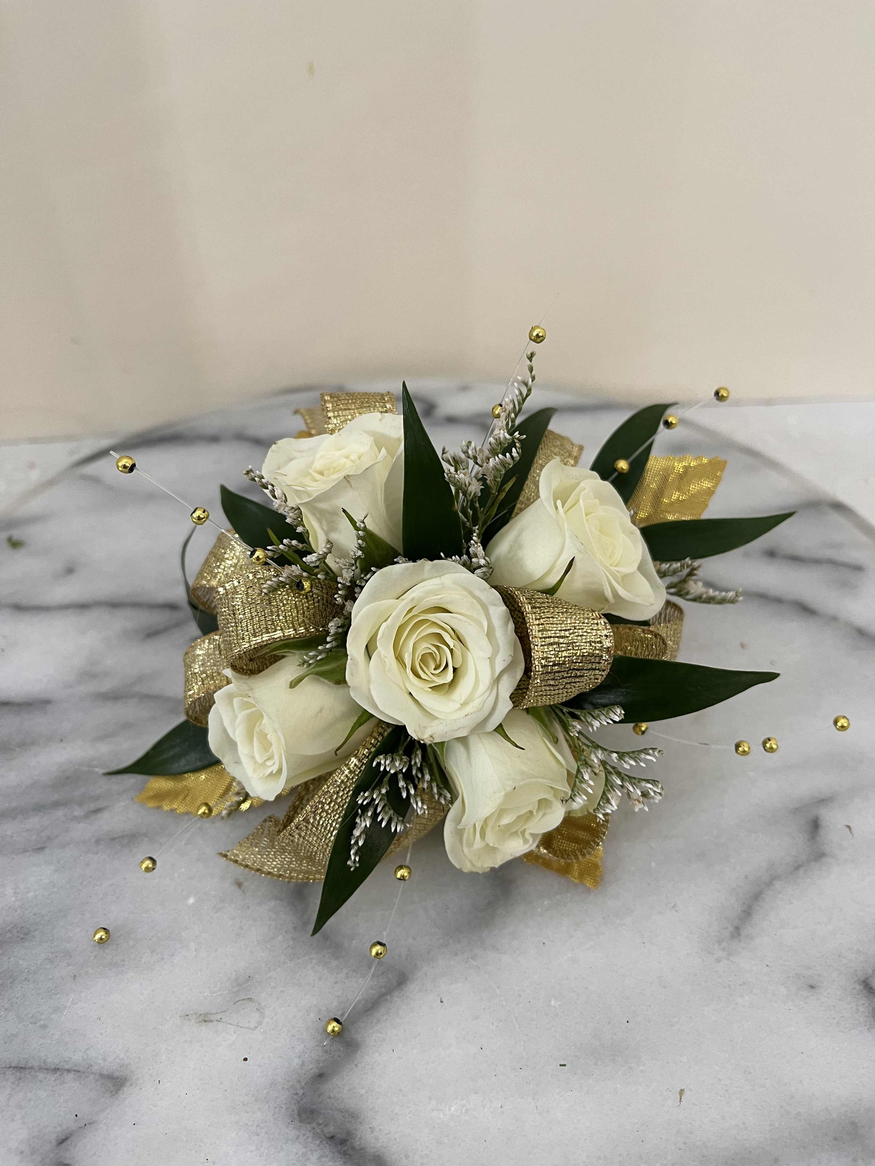 White rose bouquet with gold ribbon and decorative beads