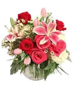 Bouquet of red roses and pink lilies in a glass vase