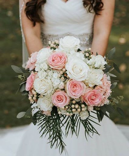 Bride holding a bouquet of pink and white roses