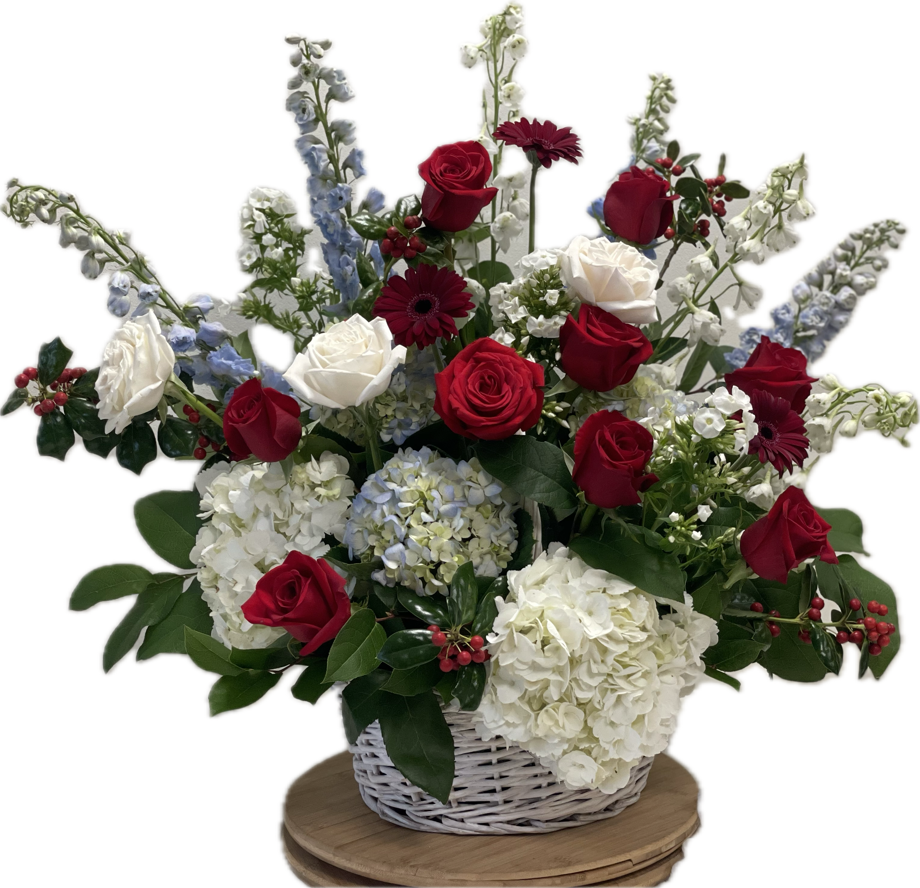 Basket arrangement of red and white roses with blue and white flowers