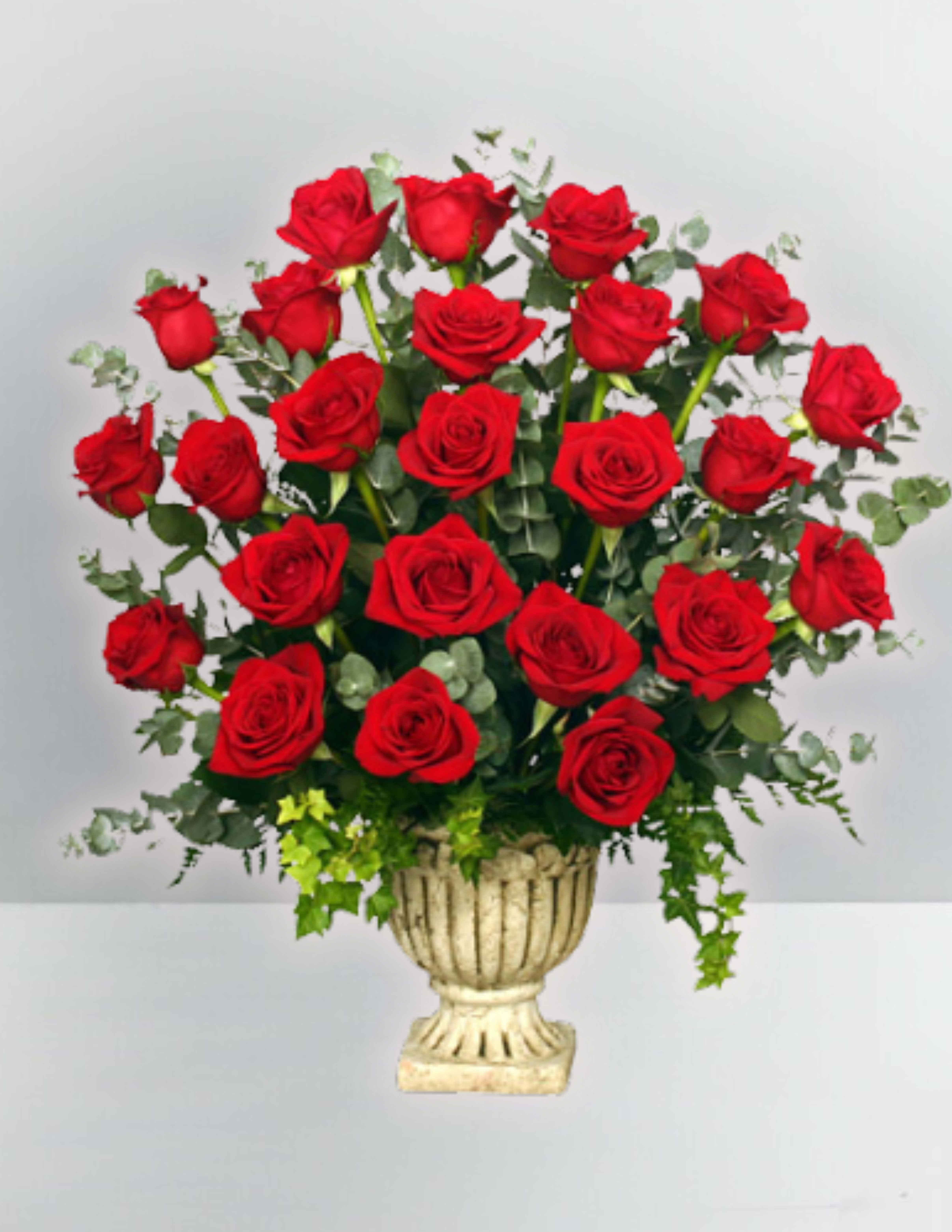 Red roses arranged in a decorative urn vase