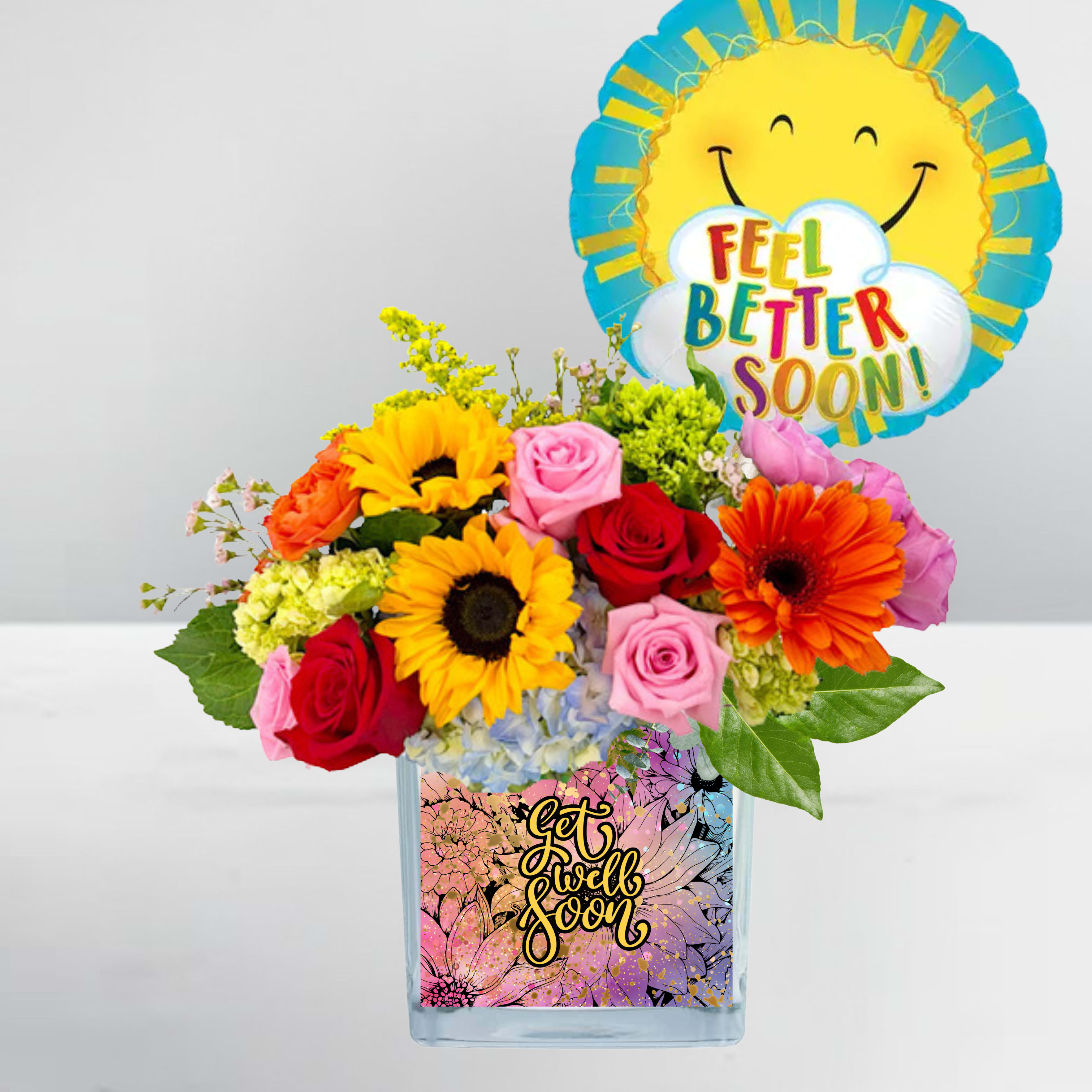 Mixed bouquet in a glass vase with a "Feel Better Soon" balloon