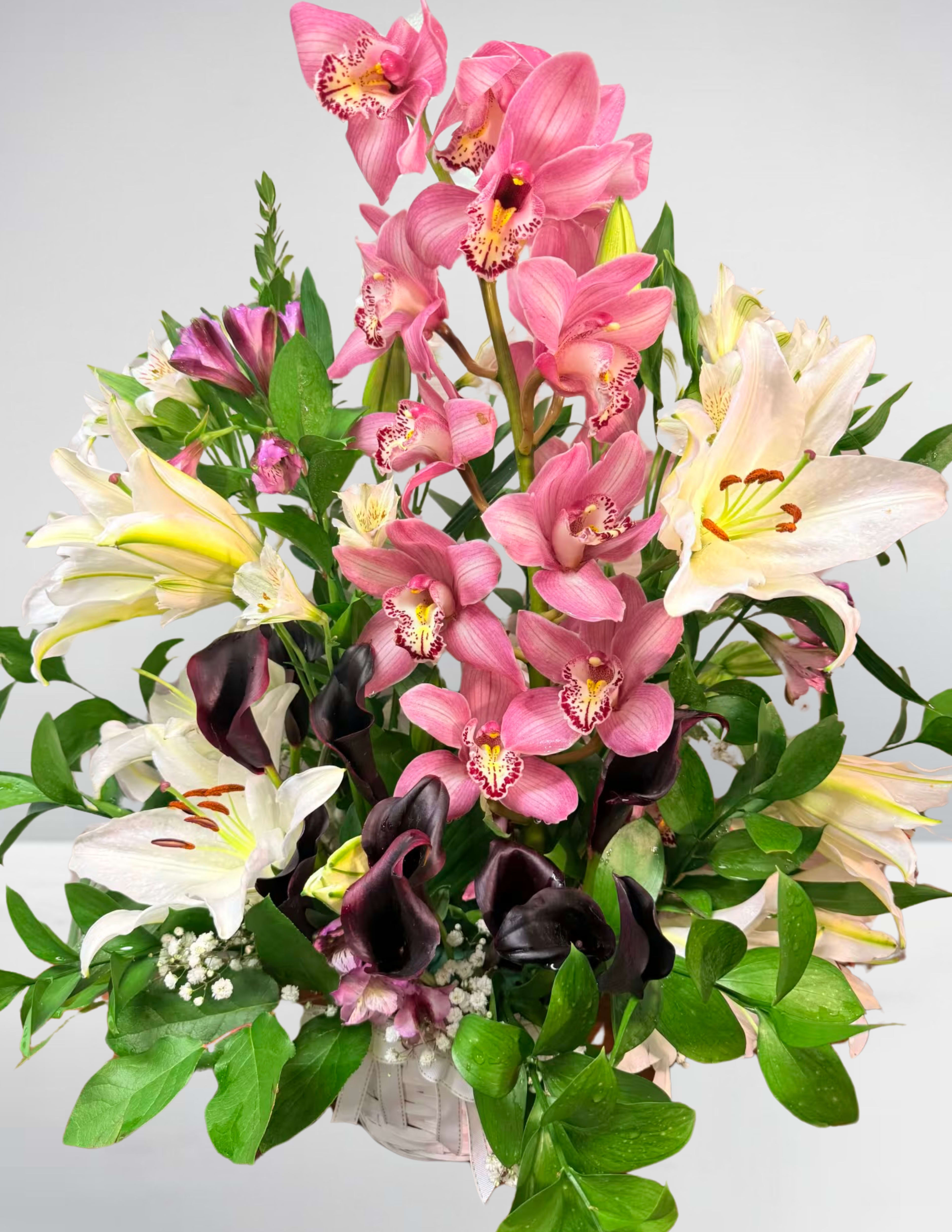Bouquet of pink orchids, white lilies, and dark calla lilies