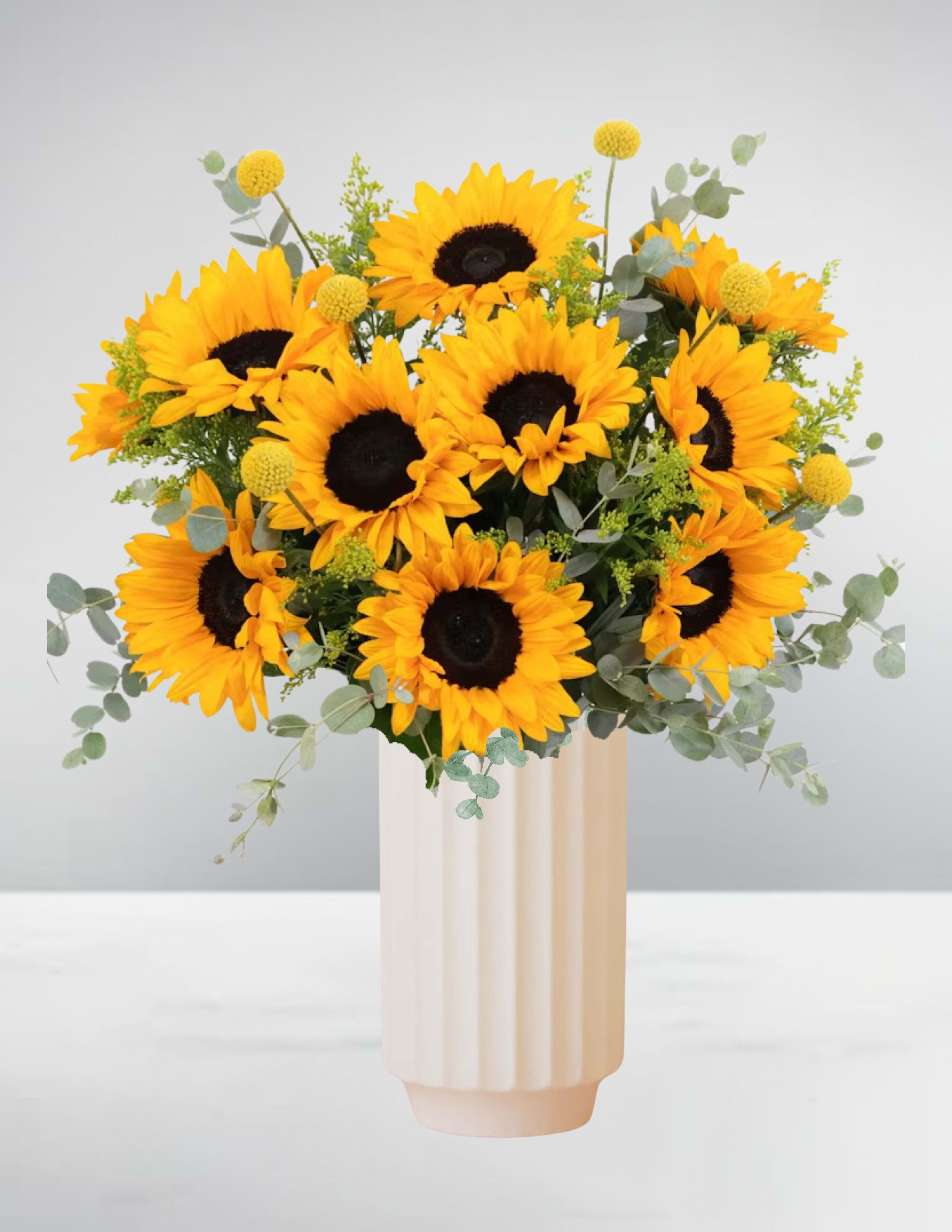 Bouquet of sunflowers in a tall cream vase