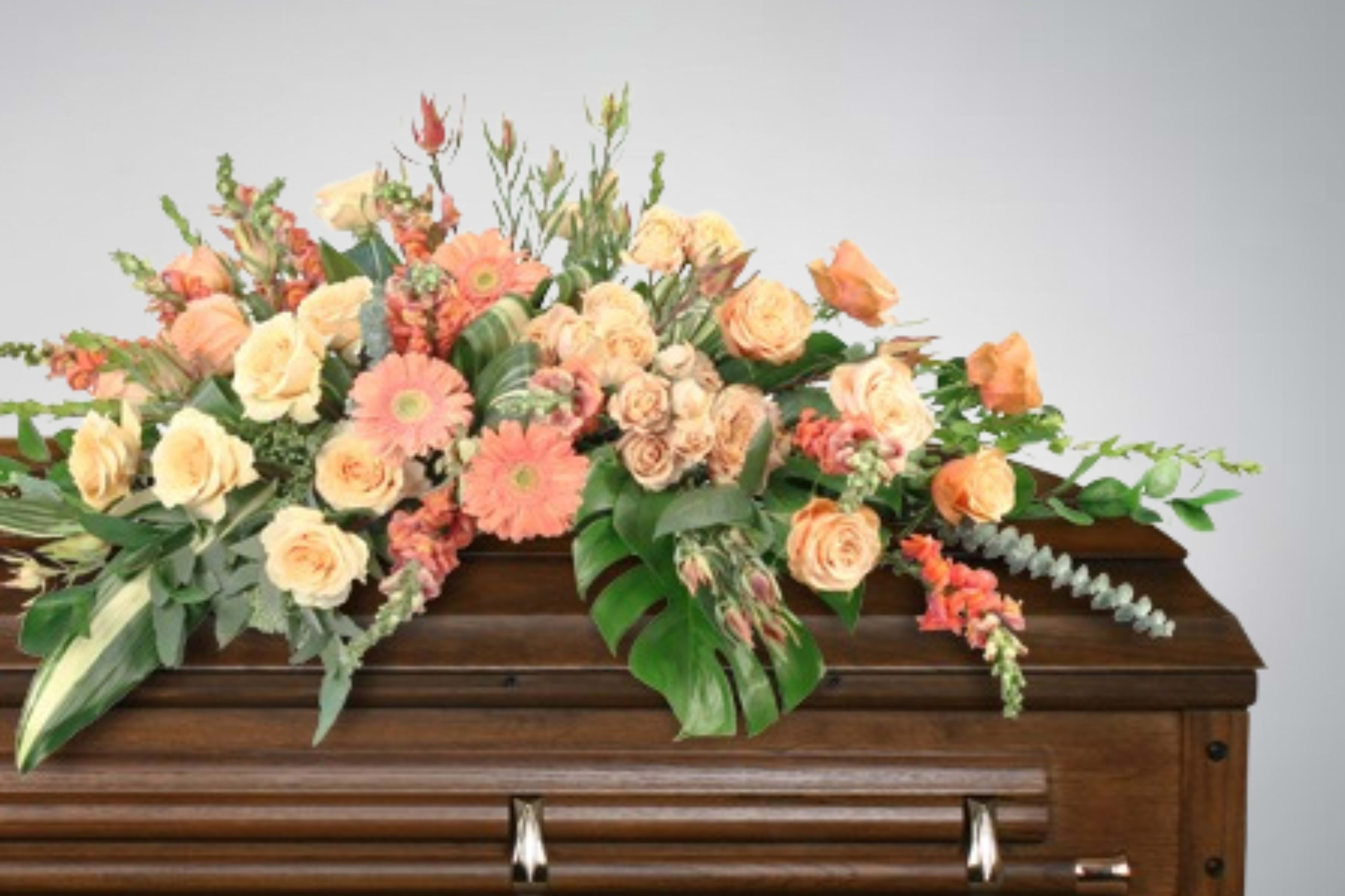 Peach and cream floral spray on a casket