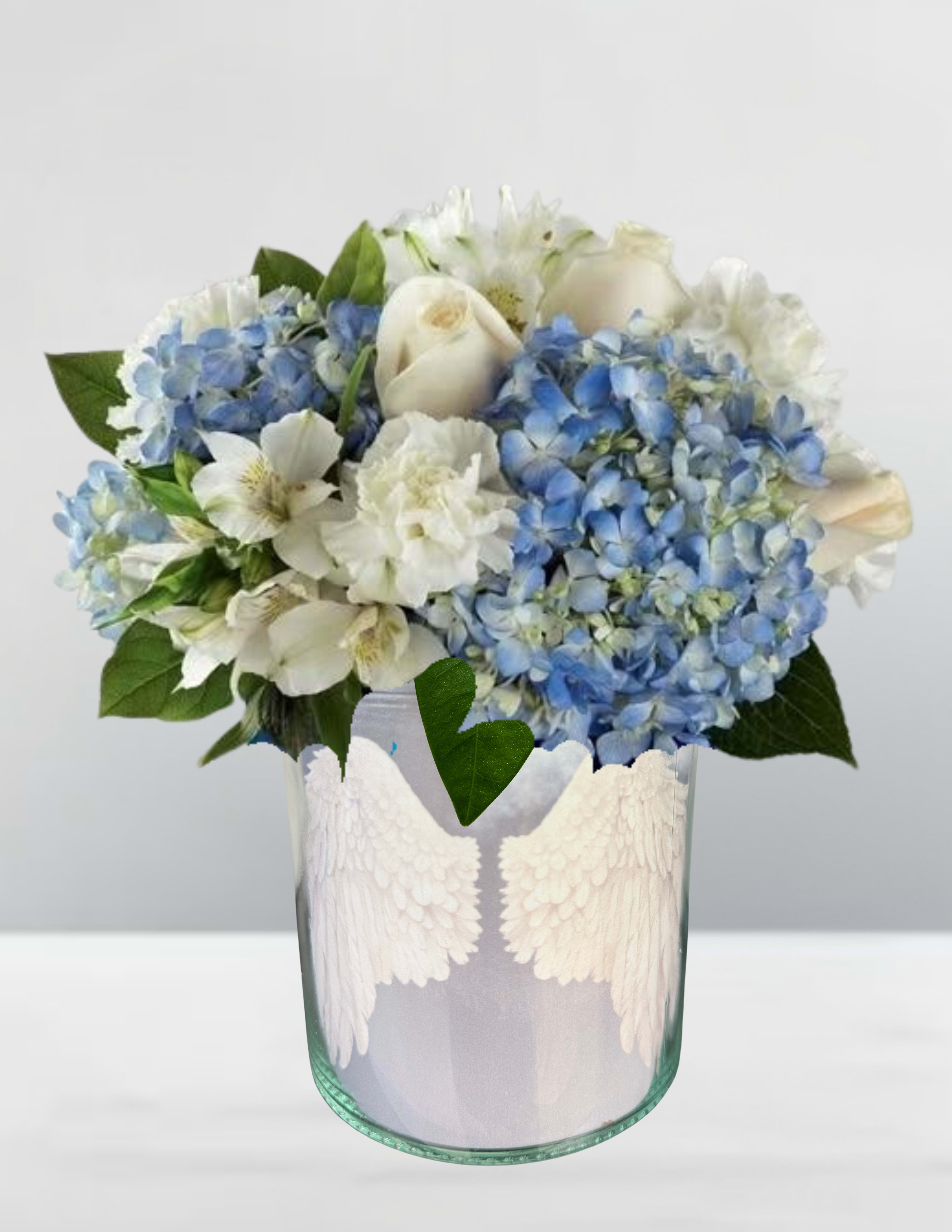 Blue hydrangeas and white roses in a glass vase