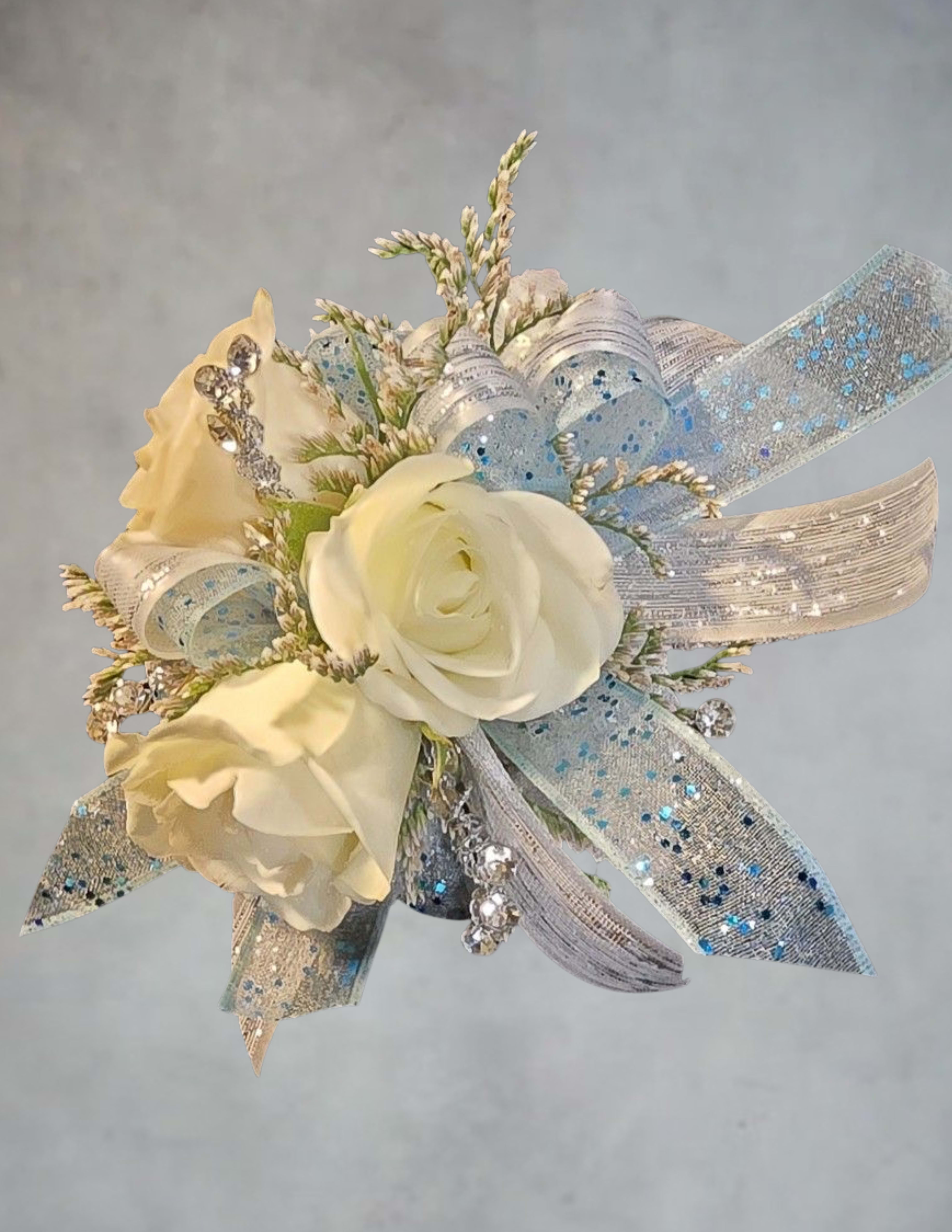 Small white rose corsage with silver and blue ribbon accents