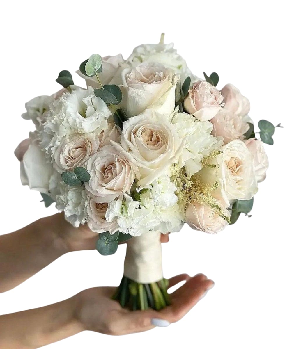 Soft Elegance Bridal Bouquet - A romantic bridal bouquet in a soft ivory + blush palette with airy white blooms and gentle touches of eucalyptus. Designed to feel timeless, feminine, and photo-perfect from ceremony to reception. This bouquet pairs beautifully with classic gowns, modern minimal looks, and garden-style weddings. Includes: premium roses (standard + spray) + seasonal white blooms (ex: lisianthus/hydrangea/stock) + eucalyptus/greens Customizable: color palette + ribbon wrap Note: Seasonal substitutions may occur, but we always keep the same color story and overall look.