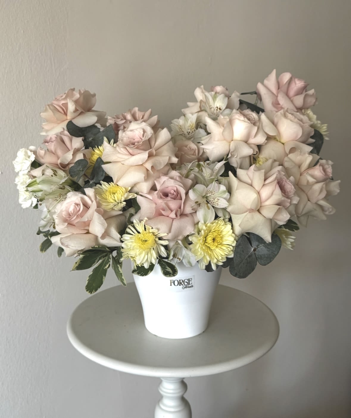Champagne Garden- dusty roses, alstroemeria, mini chrysanthemum  - A timeless arrangement featuring premium blush roses, delicate white blooms, seasonal accents, and fresh greenery, beautifully designed in a modern ceramic container. Soft, romantic, and effortlessly elegant, this arrangement is perfect for anniversaries, birthdays, celebrations, or simply expressing love and appreciation.  Please note: Flower varieties may vary based on seasonal availability while maintaining the overall style, color palette, and value of the arrangement.
